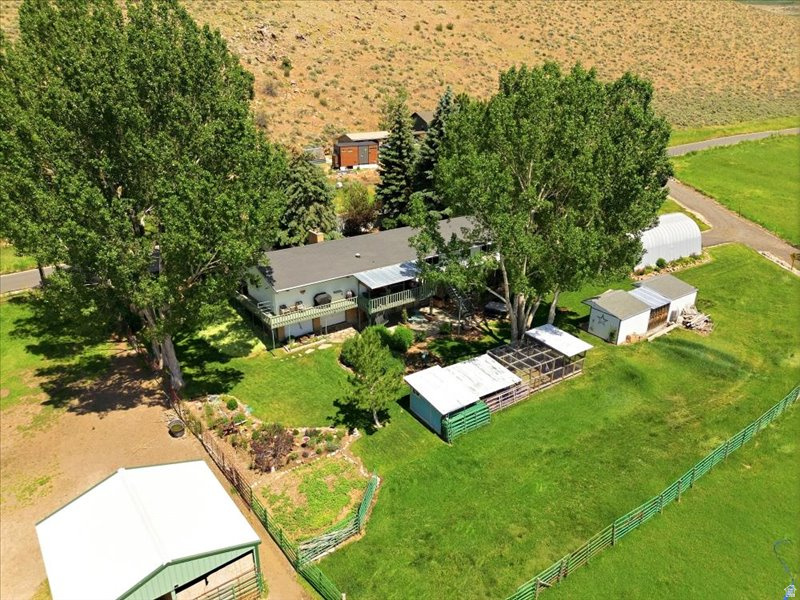 Meticulously maintained horse property in one of Kamas' most desirable locations. Enjoy unobstructed mountain and valley views, a beautifully renovated home with hardwood floors, granite countertops, and open living spaces. The immaculate grounds feature custom sheds, chicken coops, a well-manicured landscaping with mature trees and perennials for year-round beauty, and a spacious deck for sunset views. Property includes a 4-car garage, 1,000 sq. ft. arched metal building, 24x24 barn, private well, six irrigation shares, updated water lines, and upgraded HVAC. A rare opportunity offering exceptional condition, breathtaking scenery, and expansion potential.