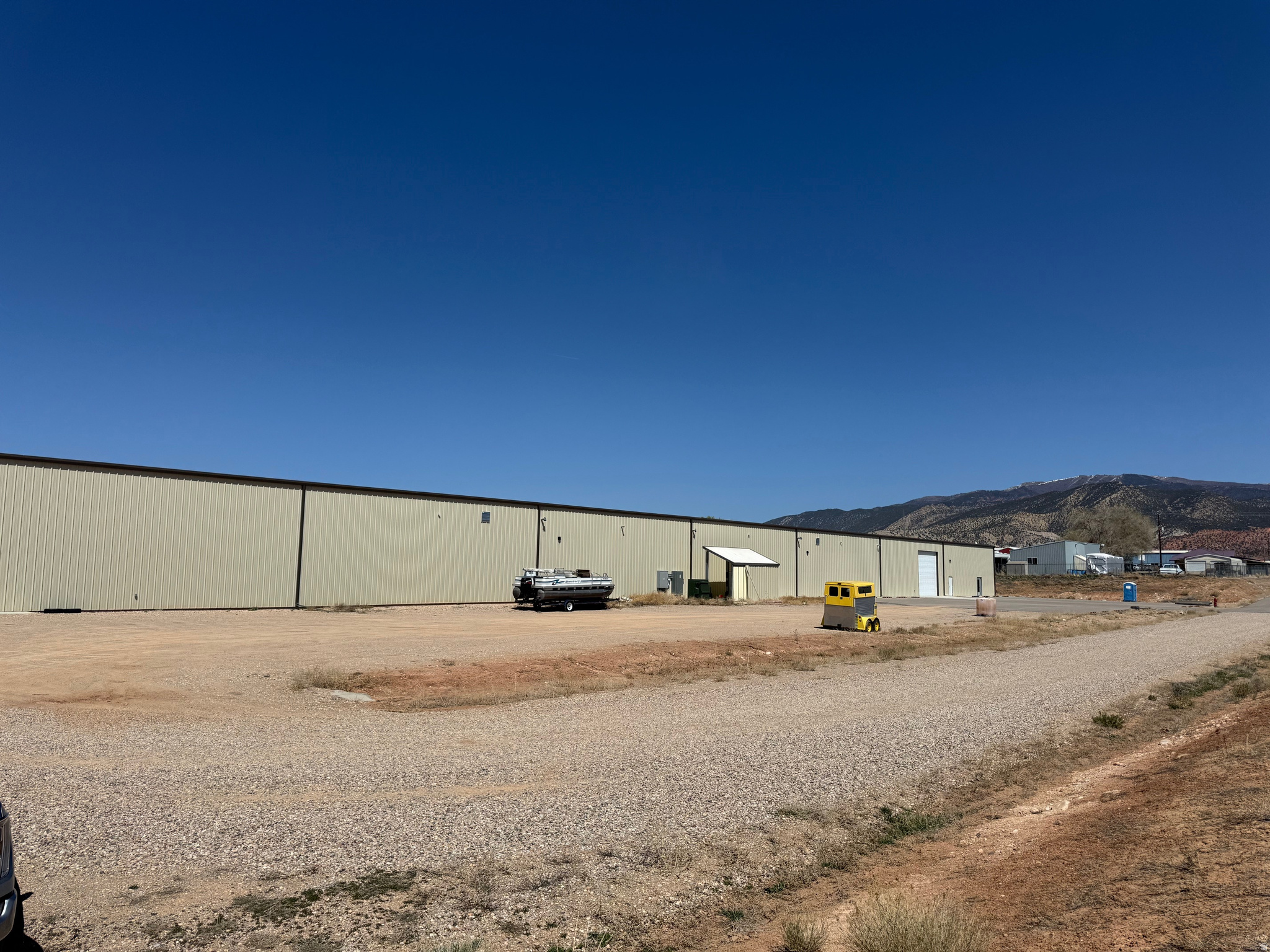 10.5 Acre parcel just off Airport Road, including a 40,000 square foot building that was built in 2023. There are 4 overhead drive through doors that line up for drive through access. It also has 1 bathroom plus 2 more that are roughed in. Several office and conference and storage rooms that are 70% finished. Heated and great lighting.
