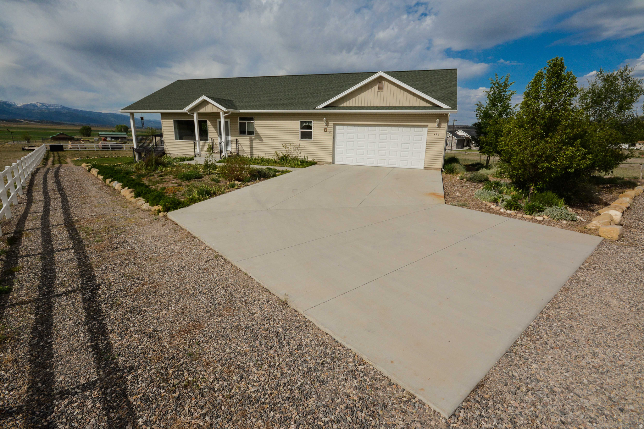 4-bed, 2-level home with open living/kitchen area, walk-out basement, full-width deck and patio, pantry, storage rooms, tankless water heater, 2-car garage/workshop, fenced -acre lot, garden, water share, chicken coop, and canyon recreation nearby.