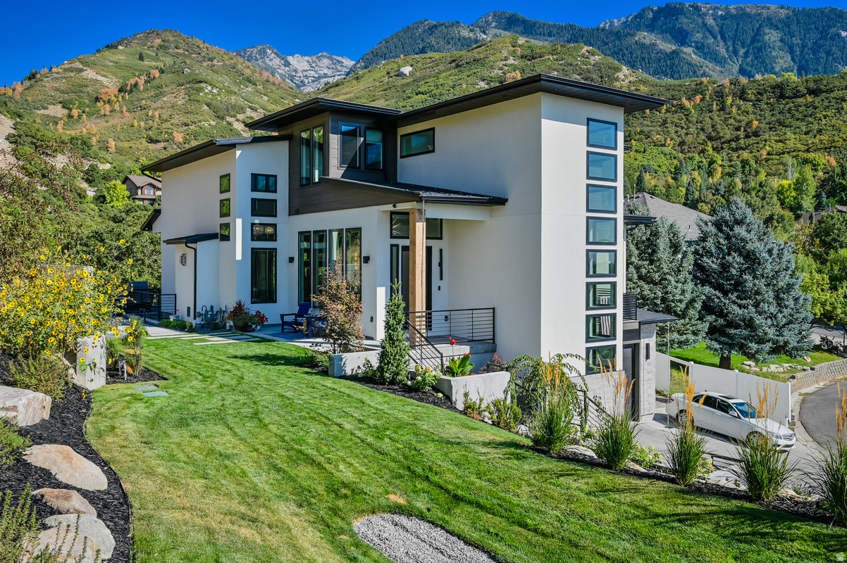 Luxury ski mountain estate at the mouth of Little Cottonwood Canyon - set on over an acre and tucked into the mountains for exceptional privacy. Surrounded by the serene seclusion of the Wasatch Front, yet perfectly positioned to capture sweeping cityscapes and stunning sunset views.   High-end, fully custom home showcasing luxury lighting, exposed steel beams, expansive windows, and oversized sliding doors, all complemented by premium finishes throughout. Extra tall custom ceilings throughout. Features a massive, uniquely designed statement wall with a fireplace and a striking concrete bench, along with a showpiece staircase and thoughtfully curated, designer-level details in every space.  Full house water filter, tankless water heater with recerc pump, plumbed for backup generator and plumbed for garage heater. Garage 220 outlet. Experience a rare opportunity to own a fully custom mountain estate perfectly positioned at the base of Little Cottonwood Canyon-just minutes from world-renowned Alta, Snowbird, Solitude, and Brighton ski resorts, and near the proposed canyon gondola. Located in a rarely available, highly coveted neighborhood east of Wasatch Boulevard, this property offers a level of privacy, setting, and proximity to the canyon that is nearly impossible to replicate. Backyard backing Bell Canyon Trailhead. Private lane, Secluded and one of a kind!  Set on a private, full 1-acre+ lot adjacent to Bell Canyon Trailhead, the home is surrounded by some of the world's most breathtaking mountain scenery.  Designed by a high-end interior designer, this residence showcases exceptional craftsmanship and uncompromising quality throughout. Expansive floor-to-ceiling windows-over 70 in total-flood the home with natural light while capturing sweeping views of the mountains, valley, and unforgettable sunsets.  The thoughtfully designed floor plan features soaring ceilings, a gourmet chef's kitchen equipped with premium Thermador appliances including a 6-burner gas range and steam oven, dual dishwashers, and three laundry sets for ultimate convenience. Incredible owner's suite with a private balcony offering unparalleled mountain and sunset views, separate huge walk-in closets, a make-up counter and a large soaker tub with an infrared sauna.   Indoor-outdoor living is elevated with a stunning deck and expansive patio spaces, gas firepit, massive built in seating perfect for entertaining or relaxing in total privacy.  A massive est 48-foot-deep garage offers exceptional storage for multiple vehicles, recreational vehicles or boat, and more.  Located just 20 minutes from Salt Lake City International Airport and a short drive to Park City, this home provides unparalleled access to world-class skiing, hiking, mountain biking, and year-round outdoor adventure-all from one of Utah's most coveted canyon locations.  A true legacy property in one of the most exclusive settings at the gateway to Utah's premier ski resorts.   Massive tandem garage with room for a boat, truck, car, and more - plus an oversized RV pad for additional parking.  Buyer to verify ALL information provided, listed on the MLS and marketing information... information is not guaranteed.   Square footage figures are provided as a courtesy estimate only and were obtained from Tax Data.  Buyer is advised to obtain an independent measurement. Owner/ Agent