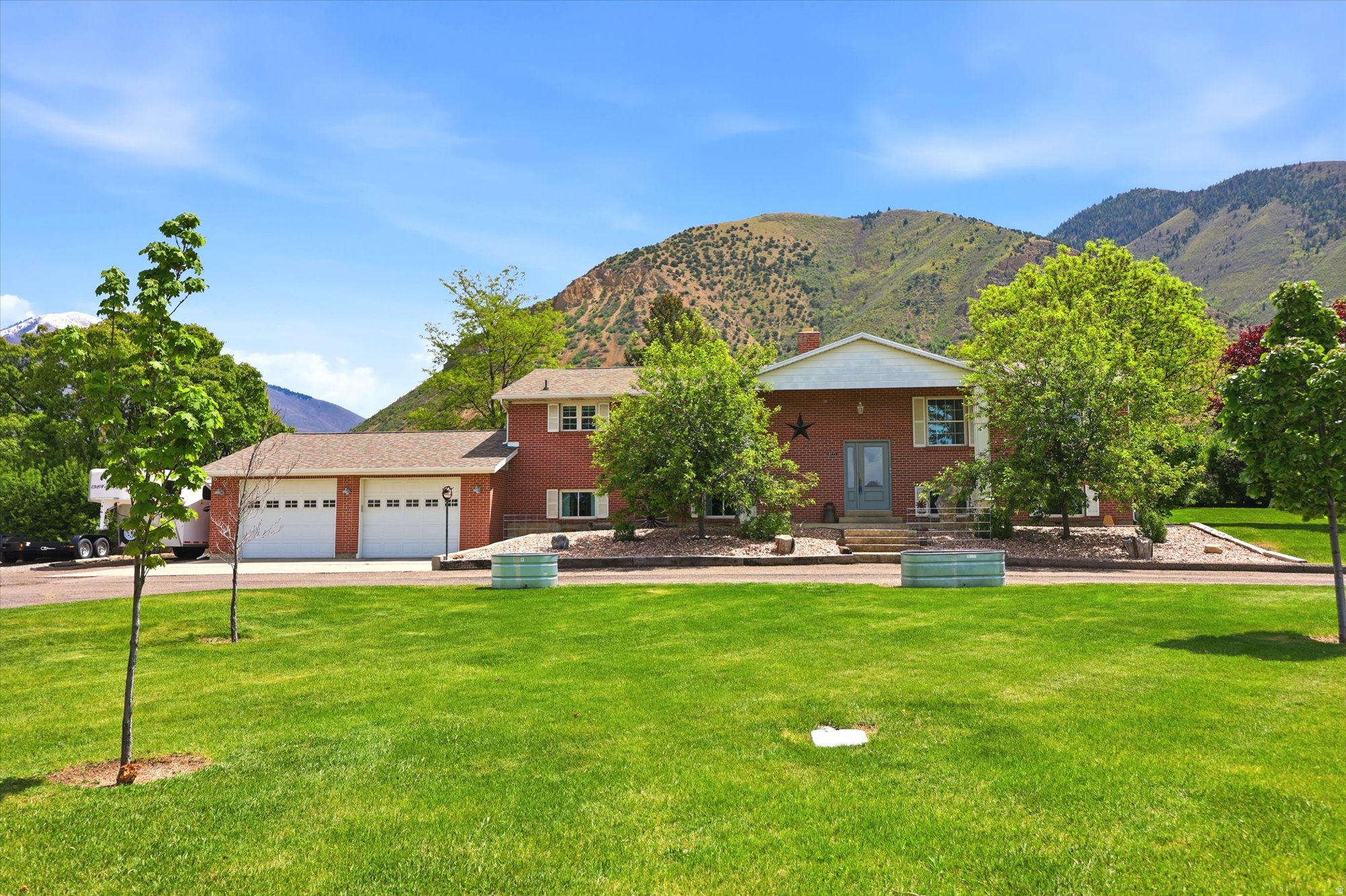 Be sure to check out the tours by clicking on the tour button.This beautifully remodeled 2+ acre horse property is located in one of Spanish Fork's most desirable and rapidly growing areas, offering exceptional potential for future development while still providing privacy and space, and includes full animal rights. The home has been fully updated with new cabinets, solid surface countertops, interior doors, moldings, texture, windows, exterior doors, lighting, backsplash, flooring, and paint, creating a clean and modern feel throughout. The spacious master suite includes a large soaking tub, separate shower, and a generous walk-in closet. The laundry room is well equipped with cabinetry and a utility sink for added convenience. Outside, the fully fenced and secluded yard is surrounded by mature trees and features a covered patio with a convenient outdoor gas hookup, perfect for relaxing or entertaining. Additional highlights include a newer roof, high-efficiency HVAC system, and a septic system replaced in 2024. The oversized garage provides ample storage and parking, and the property also includes a shed, refrigerator, and pool table, making this a rare opportunity to own a turnkey acreage property with both comfort and future upside. There are 3.5 water shares included.
