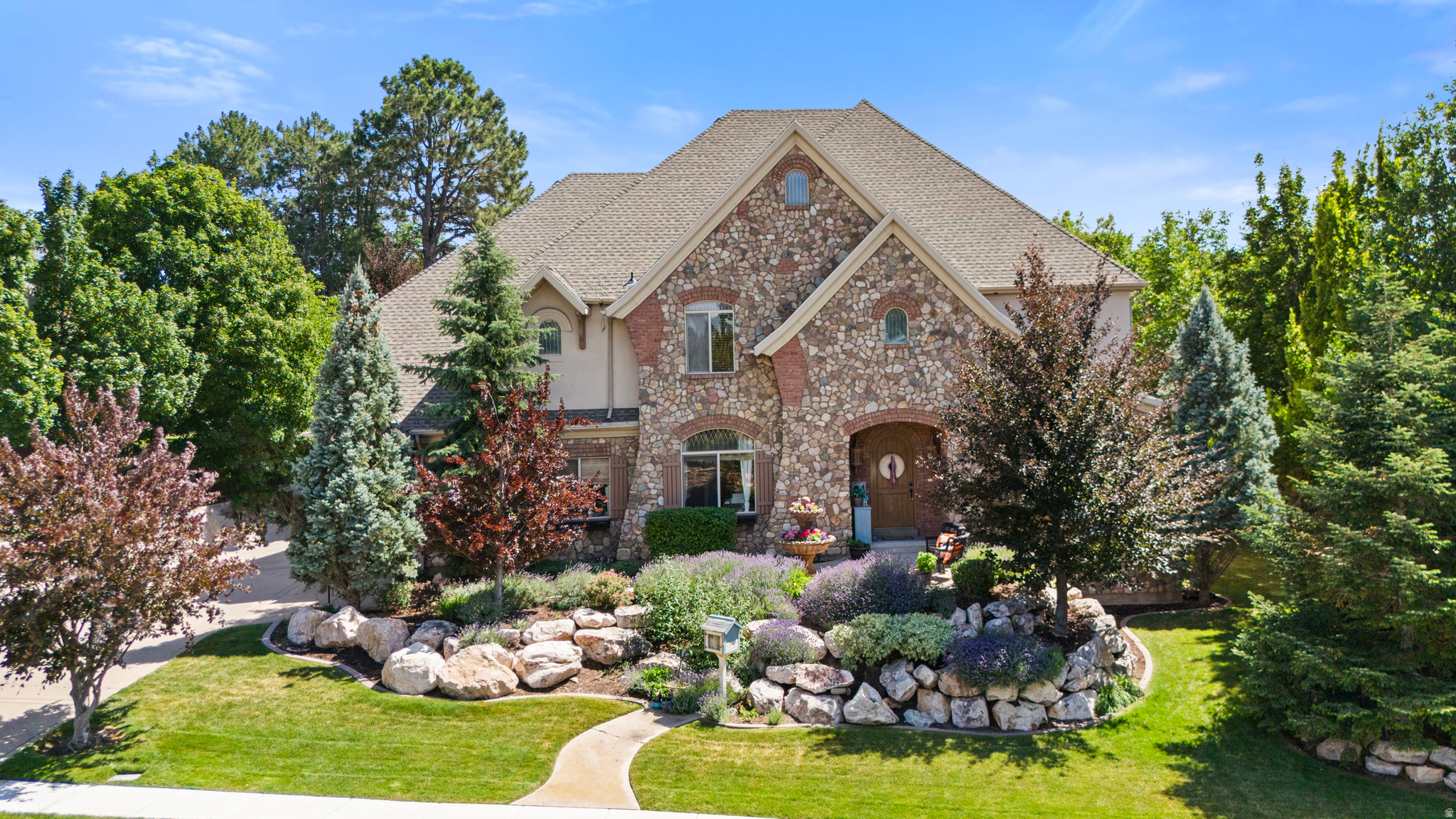 Welcome to this exceptional custom-built two-story home offering 5,668 square feet of thoughtfully designed living space. The spacious open floor plan is ideal for both everyday living and entertaining, featuring an impressive great room filled with natural light and accented by stunning custom wood trim throughout. The well-designed layout provides generous living spaces while maintaining a warm and inviting feel. This home has been meticulously maintained and updated with major improvements, including a new roof, new energy-efficient windows, and owned solar panels to help reduce utility costs. The oversized 4-car garage features an EV charging station and offers abundant space for vehicles, storage, and hobbies. Thoughtfully designed exterior lighting enhances the home's curb appeal while creating a warm, inviting atmosphere after sunset. Combining timeless craftsmanship with modern upgrades, this one-of-a-kind home delivers exceptional quality, comfort, and functionality in one remarkable package. Don't miss the opportunity to own this beautifully built custom home.
