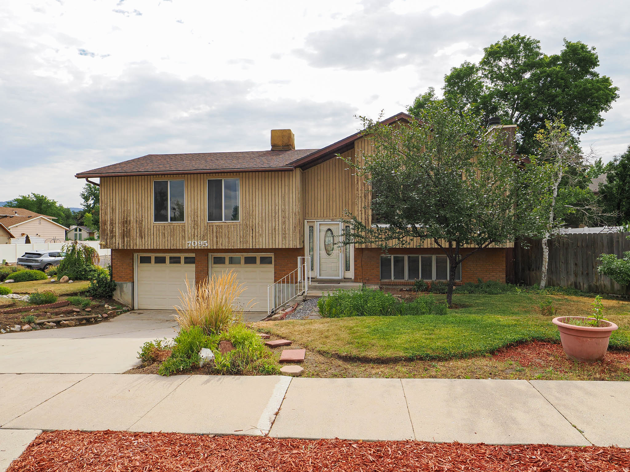Wonderful Midvale split level packed with potential. This home is tucked away on a side street/cul-de-sac and offers a fantastic opportunity to build equity and make it your own.  With a spacious layout and solid bones, it's ready for your personal updates and vision.  The asking price reflects it's condition and is sold "as is".  Nestled in an established neighborhood, the location is unbeatable.  Commuters will love the freeway access and how close it is to the best shopping, dining, parks and recreation areas.  The beautifully maintained front yard offers wonderful curb appeal.  The fully fenced backyard provides the opportunity to update on this spacious .20 acre property with mountain views.  The interior is bright and open!  Newer SS appliances, kitchen cabinets and master bathroom.  The living room with a vaulted ceiling, is centered around a cozy fireplace, making it the perfect gathering space. The kitchen dining area is spacious.   Don't miss this 4 bedroom, 3 bathroom home in the heart of Midvale.
