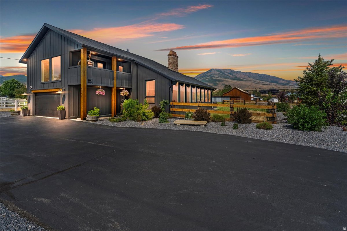 Set on over an acre in the heart of Ogden Valley, this property isn't just a house-it's a fully built-out lifestyle. Thoughtfully redesigned four years ago, every inch of this home and property has been dialed in for simplicity, efficiency, and adventure. Inside, the home offers 4 bedrooms and 3 bathrooms with a clean, updated feel that balances comfort and function. But what truly sets this property apart begins the moment you step outside. Anchoring the property is a massive 40x60 shop, offering expansive garage space along with a fully finished gym space and sauna. It's a setup that's hard to recreate and even harder to find, built for those who want space to work, train, and live all in one place. The land itself opens up endless possibilities. With pasture space for animals, custom timber fencing, mature trees, and a private pump track, this property invites you to slow down, spread out, and enjoy the lifestyle Ogden Valley is known for. Evenings are best spent in the shaded backyard or gathered around the fire pit with unobstructed views stretching toward Nordic Valley. This isn't your typical Ogden Valley home. This is your basecamp.