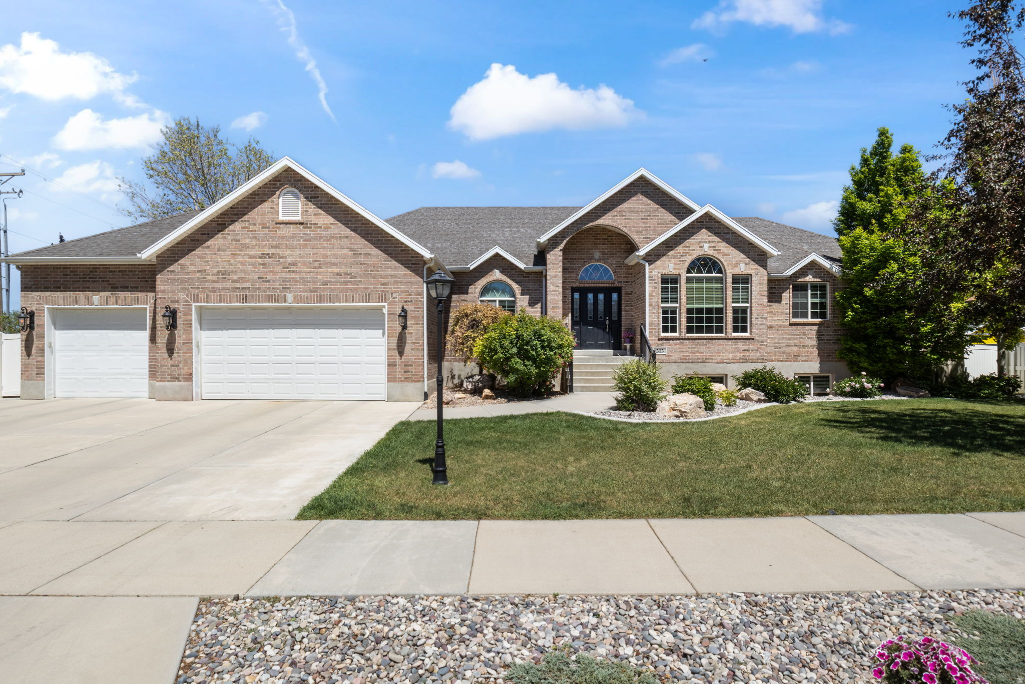Beautifully maintained Draper rambler in the desirable Willow Springs neighborhood with main floor living, a fully finished basement, and a great yard in a hard to beat location. Set on a .30 acre corner lot with mountain views, mature trees, full landscaping, automatic sprinklers, and a fully fenced backyard, this home offers the space and setting buyers are looking for.  The main level features an inviting layout with vaulted ceilings, a spacious great room, formal living room, den or office, gas fireplace, and a comfortable kitchen and dining area. With 3 bedrooms and 2.5 bathrooms on the main floor, including a primary suite with a walk in closet, jetted tub, and separate tub and shower, the home is designed for convenient everyday living.  The finished daylight walkout basement adds valuable flexibility with additional bedrooms, a large family room, and outside basement entrance, creating great space for guests, entertaining, hobbies, or extended multi-generational living needs. A 3 car garage, RV parking, covered deck, covered patio, shed, central vacuum, granite countertops, hardwood, tile, and carpet flooring add to the functionality and appeal.  Located close to Draper schools, shopping, dining, trails, parks, and commuter routes, this home combines space, comfort, and convenience in one of Draper's most sought after areas. A fully finished rambler with a walkout basement, great yard, no HOA, and a prime Draper location is one you will want to see.