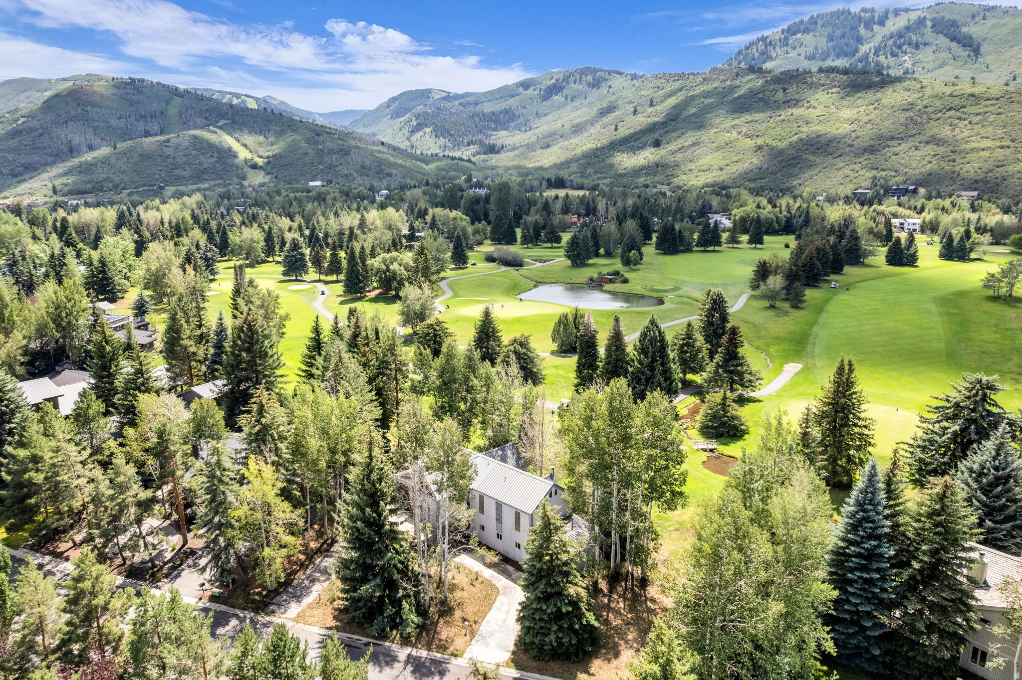 Inspired by a contemporary interpretation of Park City's historic Silver King Coalition Mine, this one-of-a-kind custom residence celebrates the town's legendary mining heritage while offering an exceptional opportunity in the heart of Thaynes Canyon. Thoughtfully designed by its owner to reflect one of Park City's most iconic landmarks, the home is a rare chance to own a property with a meaningful connection to the community's history.  Ideally positioned along the 8th tee box of the Park City Golf Course, this in-town location offers effortless access to Historic Main Street, Old Town, Park City Mountain Resort, Deer Valley Resort, world-class skiing, hiking and biking trails, restaurants, shopping, and nearby public transit for year-round convenience and adventure.  The flexible floor plan features four bedrooms and three bathrooms, including a private mother-in-law suite that offers exceptional versatility for extended family, guests, a home office, or multi-generational living. Expansive windows, generous gathering spaces, and distinctive architectural details showcase the home's custom design while providing the perfect canvas for its next owner to add their own vision and personal style.  Lovingly maintained over the years, this home is ready for its next steward to thoughtfully update, restore, or reimagine its interiors while preserving the architectural inspiration that makes it truly special. Rarely does a property combine such a compelling story, premier golf course frontage, and an unbeatable Park City location just minutes from the area's renowned ski resorts and year-round recreation.