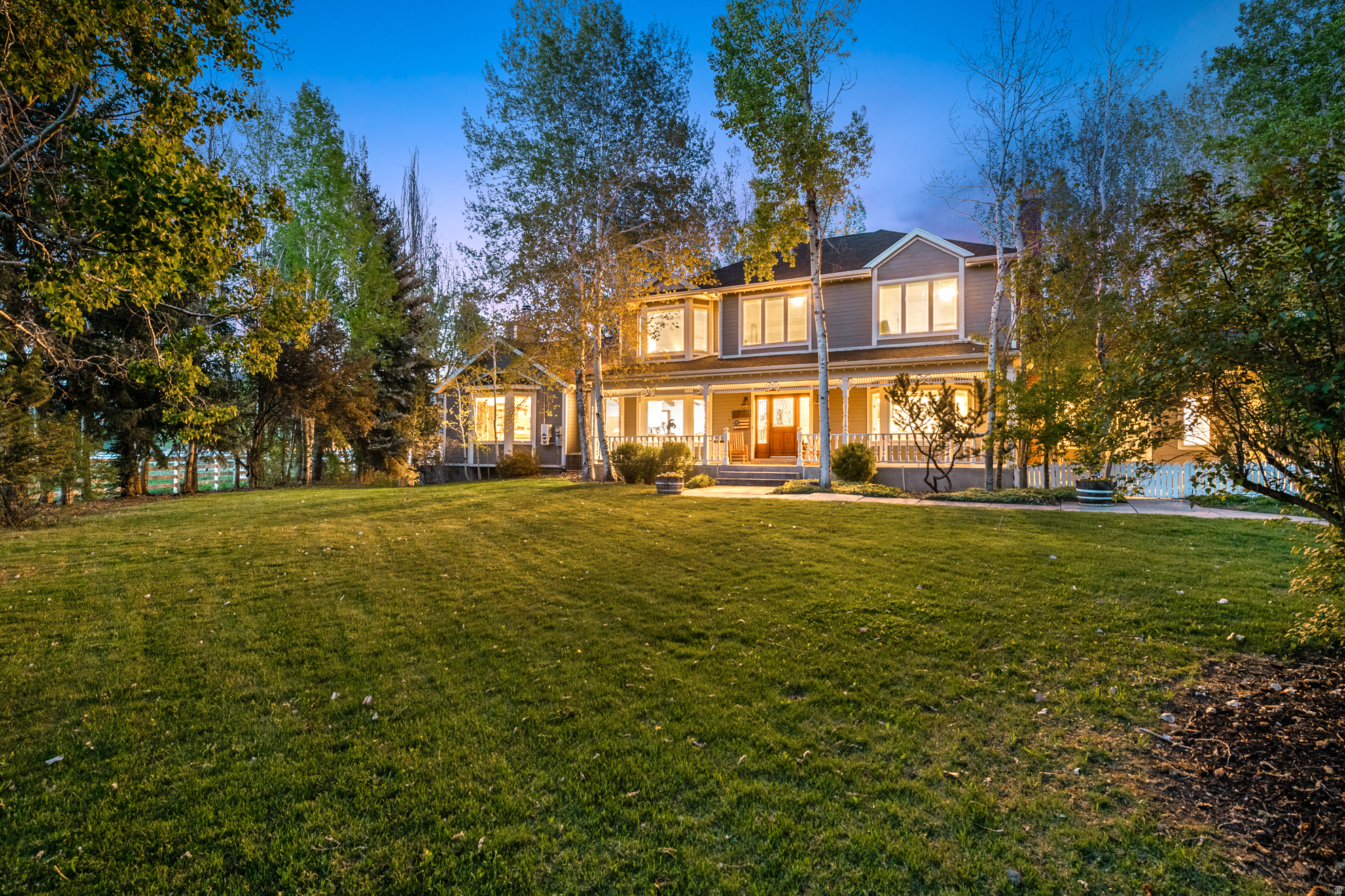 Rare opportunity to own a one-of-a-kind 10-acre equestrian property on quiet and coveted Countryside Lane, just minutes from Heber City amenities. Tucked away on a peaceful dead-end street made up primarily of 10-acre ranchettes, this property offers something increasingly hard to find in Heber Valley: usable acreage, water, privacy, horse amenities, mature landscaping, and close-to-town convenience all in one.  Designed for the horse and ranch lifestyle, the property features irrigated hay fields, 15 shares of Timpanogos Irrigation Company water, and pressurized wheel lines. The outdoor riding arena is surrounded by mountain and valley views, with beautiful sightlines toward Snake Creek, Mount Timpanogos, and the surrounding mountain ranges.  Equestrian improvements include two automatic horse-watering troughs, white vinyl and pipe fencing, piped hitching posts, and a substantial 45x75 barn with approximately 3,375 square feet. The barn includes horse stalls, a tack room, shop, bunkhouse, hay storage, and equipment storage. A spacious staging area provides room to park, load, and turn around trucks and trailers, with a newer three-sided hay barn nearby.  From the mature tree-lined driveway to the wide lawns, established trees, and peaceful outdoor gathering spaces, the property has a true sense of arrival. The grounds include large grass yards, beautiful landscaping, full automatic sprinklers, a covered deck, gas and wood-burning fire pits, solar panels installed on the roof to help supplement the property's power, and a fully vinyl-fenced yard.  The residence offers a warm and inviting blend of space, character, and updates, with vaulted ceilings, exposed beams, stone fireplaces, an updated kitchen, generous gathering spaces, 8 bedrooms, and 5 bathrooms. The layout also includes a basement apartment and a finished mother-in-law apartment, added as part of an upstairs addition around 2001.  A rare Heber Valley offering, this property is ideal for the buyer who values land, water, horses, mountain views, privacy, and room to breathe. With 10 acres on one of Heber's most desirable ranchette streets, this property offers a lifestyle and setting that smaller luxury properties simply cannot duplicate.