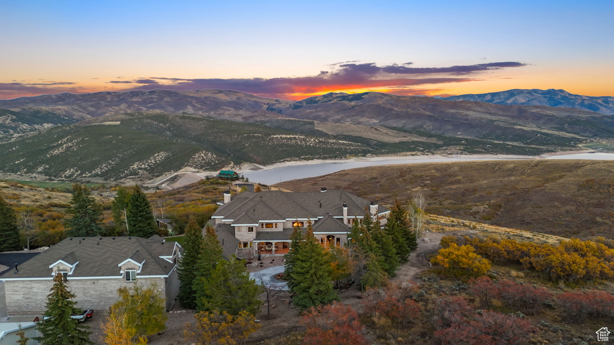 World worries? Not here because real preparedness doesn't mean hiding underground. It means thriving above it all. Arrive and relax in this gated 18,000 square foot luxury gem featuring panoramic mountain views, resort-style amenities, and a generous guest residence (Casita / ADU / Mother-in-Law Apartment) with its own private entrance and garage. Perfectly positioned on 21 secluded acres in Utah's Wasatch Mountain region, this updated property blends architectural craftsmanship, wellness-centered living, and elegance for the discerning buyer seeking space, privacy, and sophistication. Entering the primary residence, a two-story foyer with a grand staircase and crystal chandelier introduces timeless European grandeur. The open-concept main floor features arched two-story windows, vaulted ceilings, crown molding, and elegant fireplaces showcasing breathtaking alpine and lake vistas year-round. The primary suite offers a private sanctuary with balcony sunrise views, a coffee bar, and a spa-inspired bathroom with a deep soaking tub and body jet shower. Just steps away is an outdoor Pilates/cycling deck and a jetted swim spa, a true mountain wellness retreat. The walkout lower level is an entertainer's dream with a theater, wine cellar, music room, chef's kitchenette and bar, and an indoor basketball/pickleball court. Outdoors, reflect amid mature evergreens, a tranquil water feature, and abundant wildlife, including deer, elk, and various birds. Generous 13 garage bays accommodate RVs, boats, or car collections, offering at least 22 indoor parking spaces. And yes, there's more, a 7,200-sq-ft event center perfect for collectible sports cars, large gatherings, concerts, or equestrian activities. Though private and secluded, the estate is just 17 miles from skiing at Canyons Village and approximately an hour from Salt Lake City International Airport. This luxury estate exemplifies resort-style living surrounded by nature, the perfect blend of privacy, craftsmanship, and wellness in one extraordinary mountain retreat for those who prefer trees over traffic.