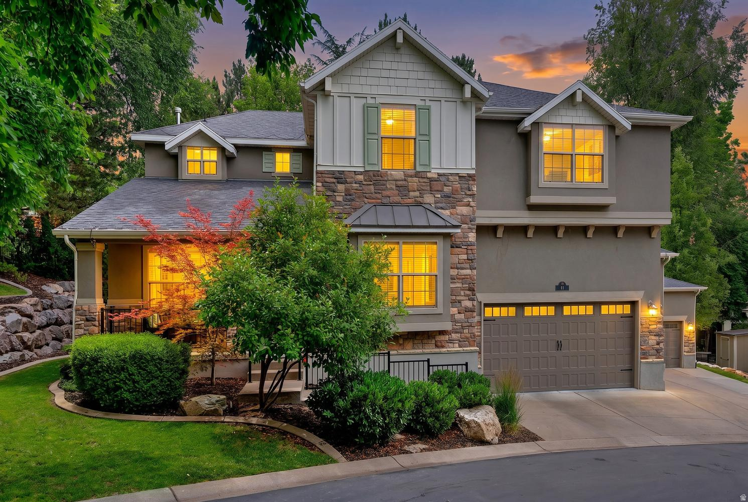 Welcome to Grove Creek, one of East Farmington's most coveted gated communities, where mature trees and an elegant entrance set the tone before you even reach the driveway. This stone and stucco craftsman style home offers warmth and character from the moment you arrive. Inside, soaring two story ceilings fill the living room with natural light, anchored by a striking fireplace and custom built in cabinetry. Fresh paint and hardwood floors run throughout the main living spaces. The expansive primary suite is a true retreat with vaulted ceilings and a generous bonus area currently styled as a sitting room, easily reconfigured into a private office, exercise room, or second bedroom. A dedicated theater room, fully finished basement, covered deck, hot tub pad, and oversized three car garage complete this exceptional offering. Set on a generous third acre lot at the end of a quiet cul-de-sac, this home delivers the privacy and prestige Grove Creek is known for. Farmington schools. Minutes to Station Park, I-15, and FrontRunner commuter rail.