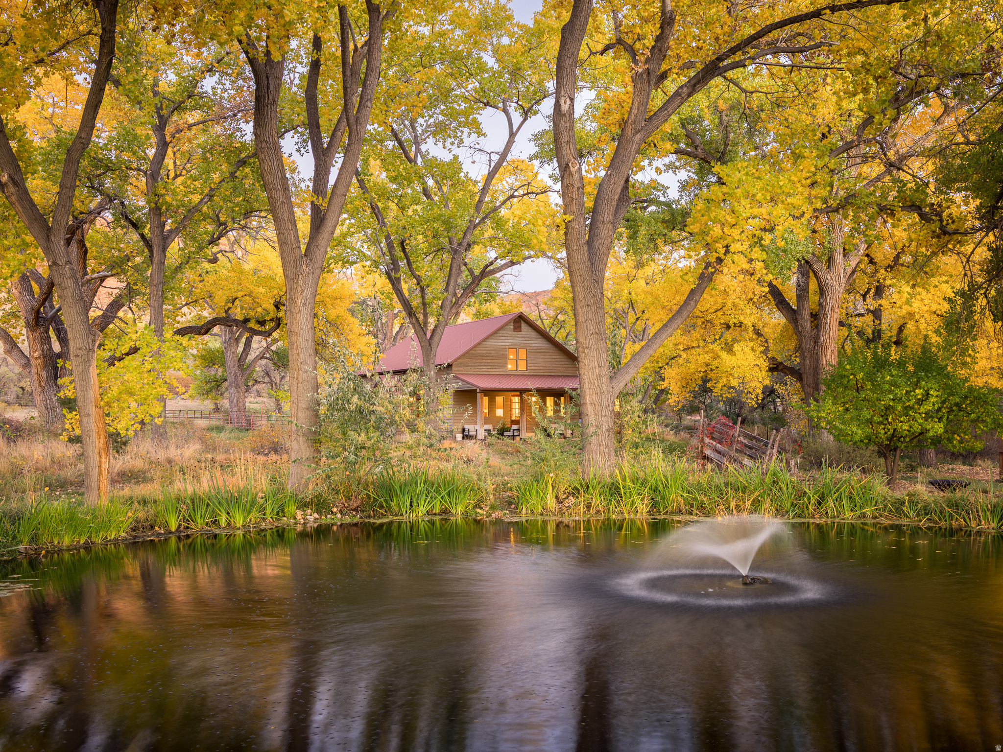 Oasis Under the Cottonwoods!  This private and secluded ranchette, rich with canopies of seasonal colors and shade, sits within a protected wildlife conservation corridor connecting Pack Creek to Mill Creek, offering a rare blend of tranquility and accessibility. Lush and green amidst the high desert's deep red earth, it's a peaceful retreat just minutes from the heart of Moab's adventure, recreation, and services. Enjoy direct access to hiking, biking, horseback riding, and golf, all from your doorstep. The property includes an abundance of water with a well with deeded water rights, additional surface irrigation shares, fed into an upgraded irrigation system featuring wheel lines, hand lines, underground lines, and stunning pond. The large hay field yields up to four cuttings per year, with two additional smaller pastures ideal for rotational horse grazing. The conservation easement protects the land's natural beauty for generations while allowing for a corral, barn, caretaker's home, guest house, or educational center, as well as a garage, shop, or home expansion. An attractive three-bedroom home is move-in ready and features refinished hardwood floors, vaulted tongue and groove ceilings, a new energy-efficient mini-split climate control, hot water radiant heat,  modern appliances, as well as all furnishings. This expansive homestead your soul has been seeking is ready for your immediate enjoyment.