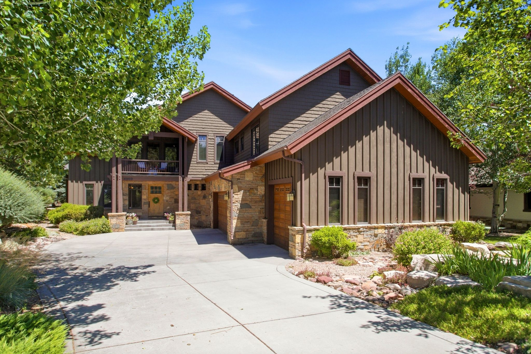 Nestled on a beautifully landscaped .43-acre lot in the prestigious Willow Creek Estates neighborhood, this exceptional 5,130-square-foot mountain retreat offers the perfect blend of luxury, comfort, and timeless design. Thoughtfully designed for both everyday living and entertaining, the home features 5 bedrooms and 5 bathrooms, including two spacious ensuite primary suites, one conveniently located on the main level. The dramatic floor-to-vaulted-ceiling rock fireplace serves as the stunning centerpiece of the home, complementing soaring ceilings, expansive windows, and warm mountain finishes throughout. Step outside to a peaceful, private backyard retreat, ideal for relaxing or entertaining. A spacious three-car garage provides abundant storage for vehicles and all your year-round recreational gear. Ideally located near world-class skiing, countless golf courses, top-rated schools, and Park City's renowned trail systems! This remarkable home truly offers the very best of mountain living.