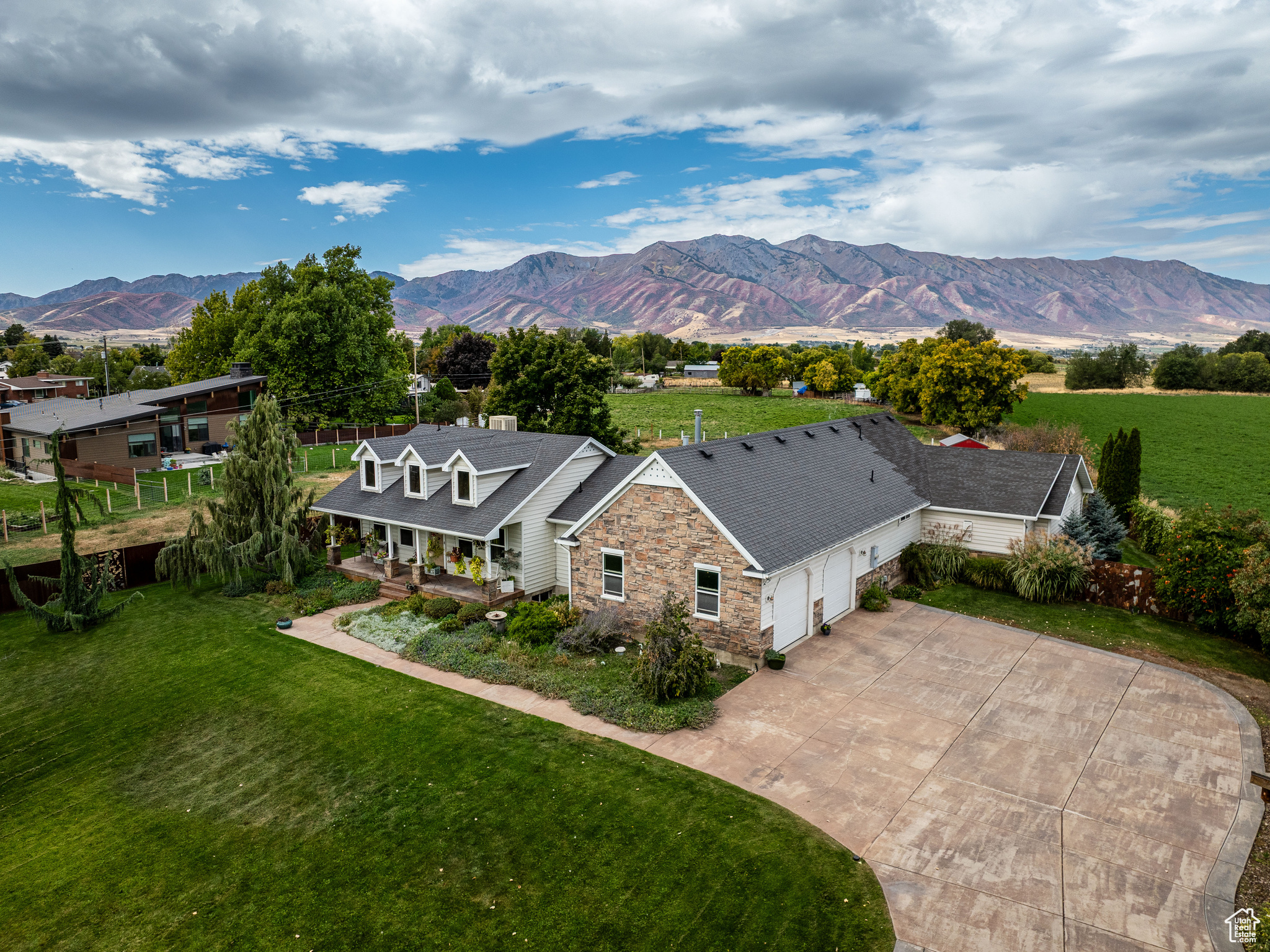 Price reduced motivated seller!! Welcome to your dream estate in the heart of Hyrum, Utah. This beautifully designed 4,399 sq ft home offers panoramic views of the Wellsville Mountains-best enjoyed while swimming laps in your private indoor pool.  The home features 5 spacious bedrooms and 4 bathrooms, including a generously sized primary suite on the main level, perfect for comfortable, single-level living.  Set on 1.36 acres, the property provides both privacy and functionality. The serene backyard includes a custom fence designed by artist Malen Pierson, adding a truly unique artistic touch. For animal lovers or hobby farmers, there's a fenced pasture area with large gates for easy horse loading, along with pressurized irrigation to make watering effortless.  This exceptional property combines rural charm with modern amenities-a rare opportunity to own a one-of-a-kind home in Cache Valley.