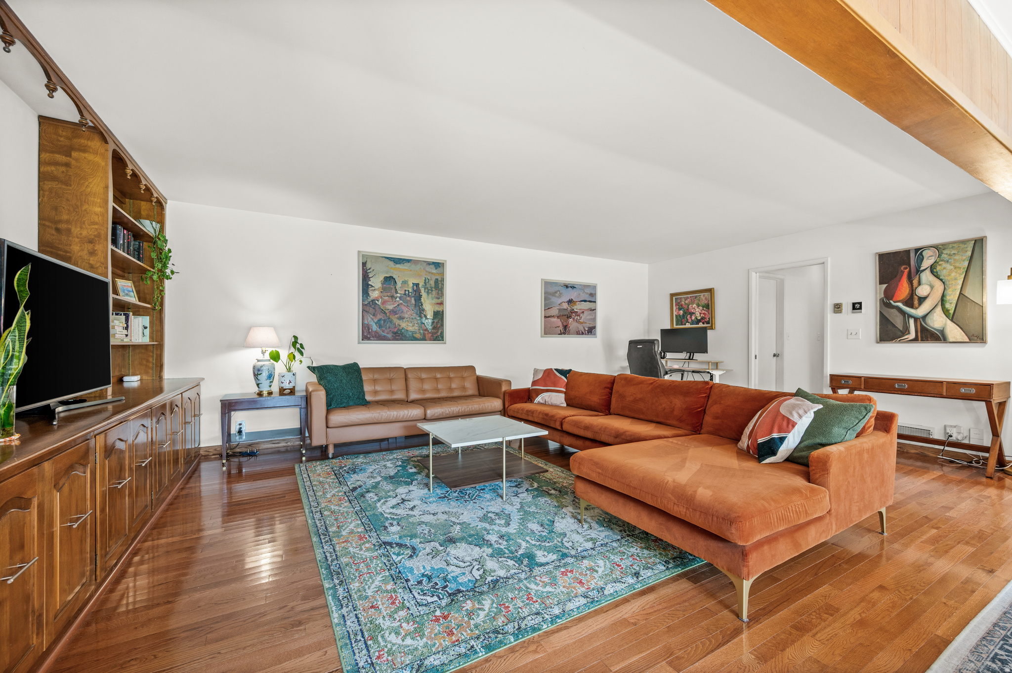 Some places chase trends. This one has defined them for decades. Nestled in the Graystone Condos, this mid-century home offers 1,450 square feet of preserved design with timeless architecture. Expansive walls of glass flood the home with natural light. At the same time, original built-ins and meticulously maintained mid-century details celebrate an era when craftsmanship, simplicity, and intention shaped every space. Designed for effortless single-level living, the home features two bedrooms, two bathrooms, updated electrical, and a seamless connection to the surrounding landscape. Every room reflects the clean lines, warmth, and understated elegance that have made mid-century modern design as relevant today as ever. Outside, mature trees and beautifully maintained green spaces create a peaceful, park-like setting, while the community pool offers a resort-style retreat just steps from your front door. Perfectly situated in the heart of Salt Lake City, Graystone Condos offers convenient access to some of the area's best dining, shopping, parks, and outdoor recreation, while maintaining a quiet, established residential setting. This is more than a condominium-it's an opportunity to own a true architectural classic. Condos with this level of authenticity, character, and design integrity rarely become available, making this a truly exceptional offering.
