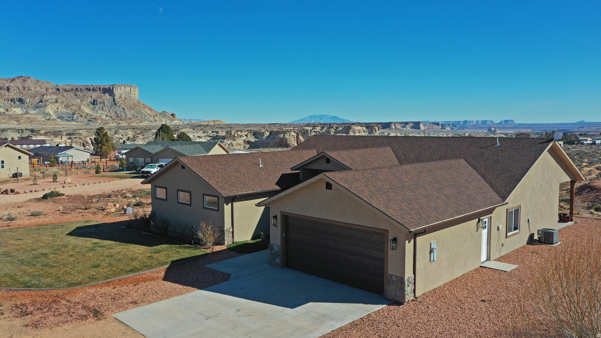 Discover this stunning 2,280 sq ft custom home on 1.57 acres with horse privileges, perfectly situated for breathtaking views of Navajo Mountain, Sleeping Chief, the Straight Cliffs, and Lake Powell. Fully ADA compliant with no stairs and roll-in showers for seamless accessibility.Inside, enjoy porcelain tile floors throughout, a gourmet kitchen featuring a 10-ft quartz island with built-in microwave and wine cooler, induction stovetop, double professional ovens, and reverse osmosis system under the sink. Custom windows flood the space with natural light and maximize those epic vistas.Outside, a front lawn with roses and trees, all on a drip/sprinkler system, plus a small garden section. Ample parking for boats or RVs. Step out to the expansive 10-ft wide covered back patio, ideal for relaxing amid the dramatic landscape. A true oasis blending luxury, functionality, and nature!   Square footage figures are provided as a courtesy estimate only and were obtained from county records  Buyer is advised to obtain an independent measurement.