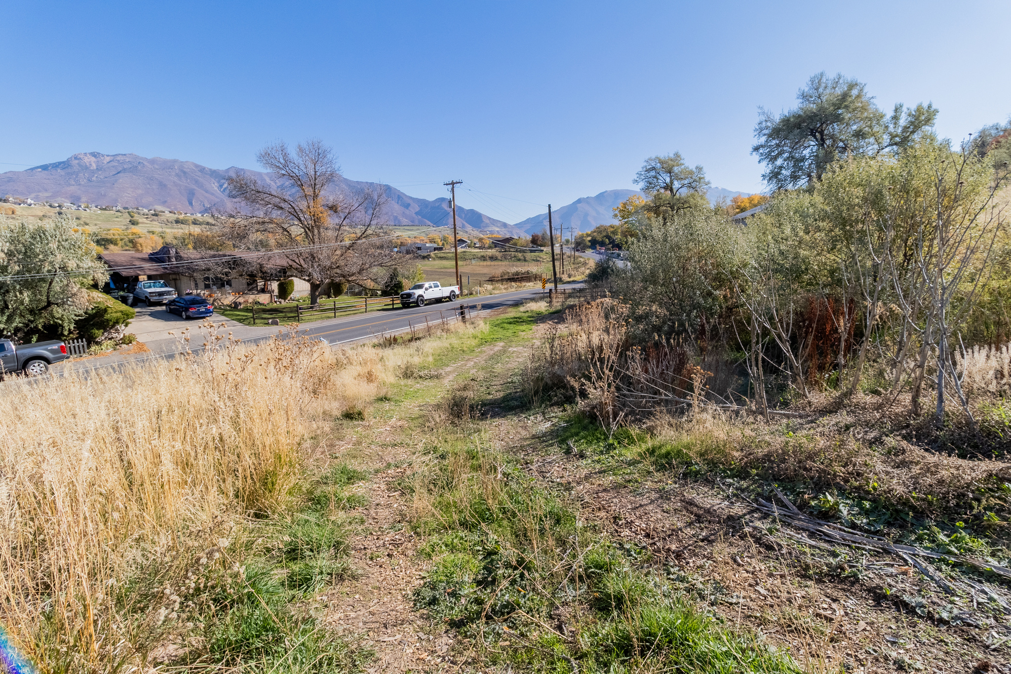 Nearly 2 acres in Riverdale along South Weber Drive!   Spectacular views in every direction, plus your own collection of fruit trees, berries, and mature plantings. Because the Air Force Base restricts the construction of a residential dwelling, this isn't your typical homesite-but that's exactly what makes it special.  Out here, the sky's the limit on what you can build. Think barn, workshop, RV/boat storage, mechanic's garage, toy shed, hobby space... whatever you've dreamed of having but never had the land for.  If you've been looking for wide-open space with unbeatable views and unlimited potential, this is it.