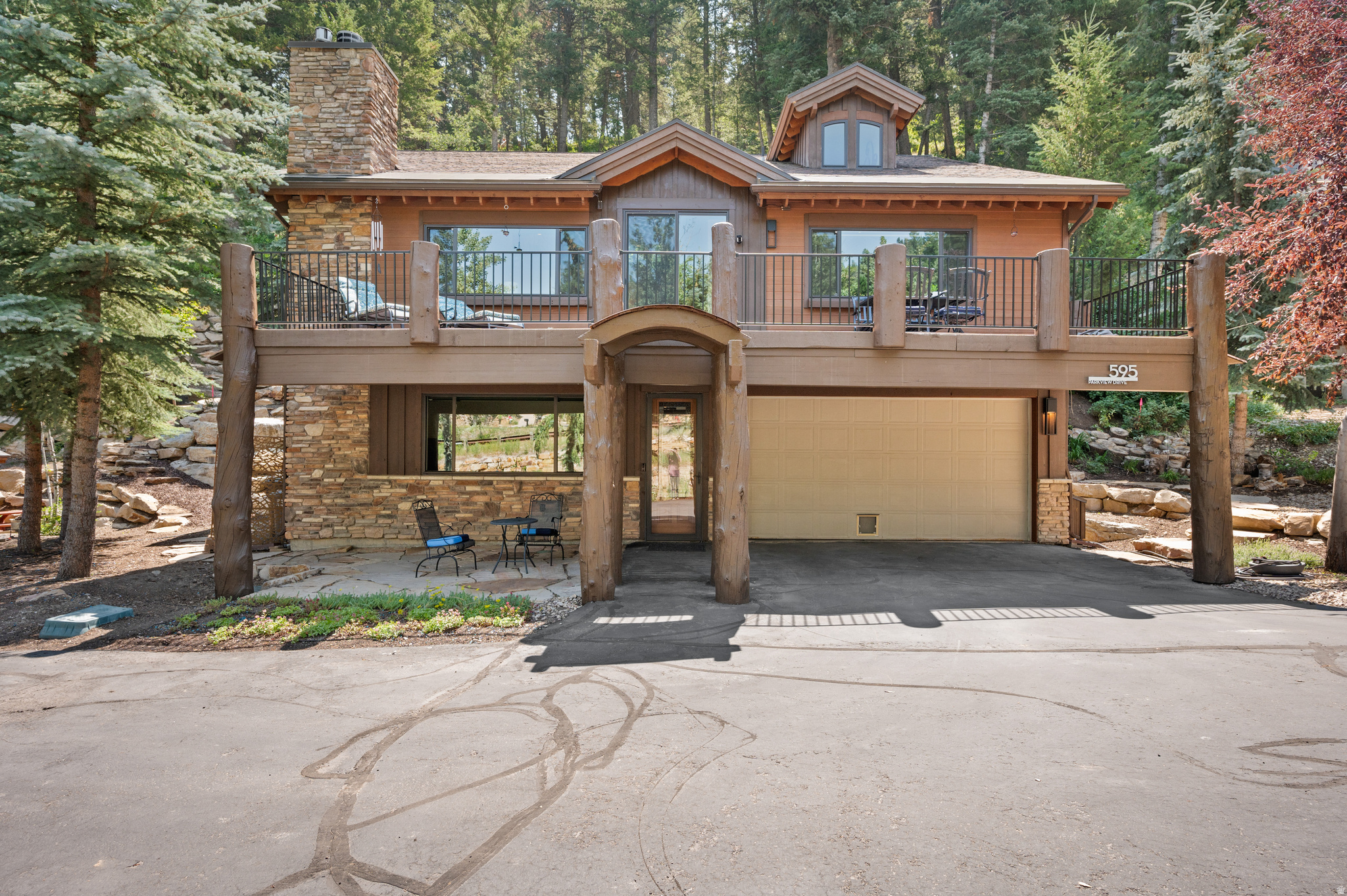 Turnkey Park City mountain retreat nestled among the trees. Sold furnished with some exceptions. Meticulously maintained and set back from the street, this home offers exceptional privacy and a peaceful natural setting. The main level is designed for effortless entertaining, with the kitchen, dining area, and living room flowing seamlessly together. Just off the living room, the spacious primary suite features a walk-in closet, double vanity, jetted tub, and separate shower for comfort and convenience. Upstairs offers a versatile loft, two bedrooms, and a full bathroom. The lower level includes a family room, bedroom, and full bath, with the family room doubling as a game room for entertaining or watching the big game. The oversized garage provides ample storage for bikes, skis, and all your outdoor gear. Step onto the deck to enjoy mountain views and the tranquil surroundings, ideal for morning coffee or evening relaxation. Summit Park is known for some of Park City's best hiking and biking trails, as well as incredible backcountry skiing. The home is just one block from the school bus stop, making the daily commute simple and stress-free, and only minutes from Woodward Park City, world-class ski resorts, and Historic Main Street. Salt Lake City International Airport is just 25 minutes away. A voluntary HOA is available for residents who wish to participate but is not required.
