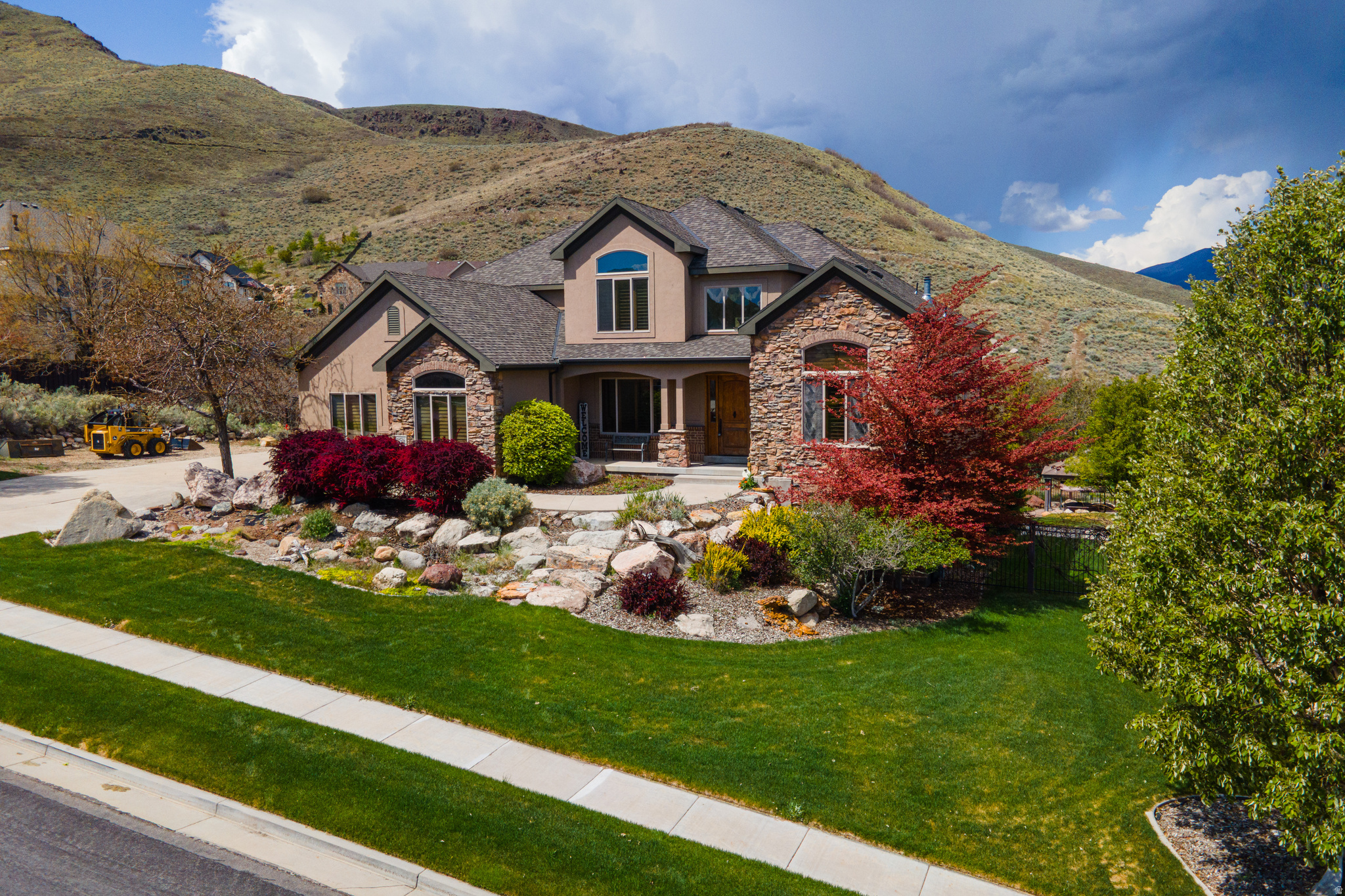Beautiful home situated on 1 acre with stunning mountain and valley views! This exceptional property features an incredible walk-out basement complete with a full kitchen, theater room, game room with 12-foot ceilings, and abundant parking that wraps all the way around to the back of the home. The fully fenced backyard offers endless possibilities for entertaining, recreation, or future additions. Enjoy the massive deck directly off the dining room and primary suite, perfectly positioned to capture unparalleled mountain and valley views. Built with remarkable quality and craftsmanship, this home impressed the home inspector so much that he called it "the best framed house he's ever seen." The property is fully landscaped with mature trees and natural scrub oak, creating a low-maintenance setting that attracts an abundance of wildlife and enhances the home's private, peaceful feel.  Located in an incredibly quiet neighborhood with hiking and biking trails right outside your front door, this home truly checks every box.  A rare opportunity you do not want to miss!