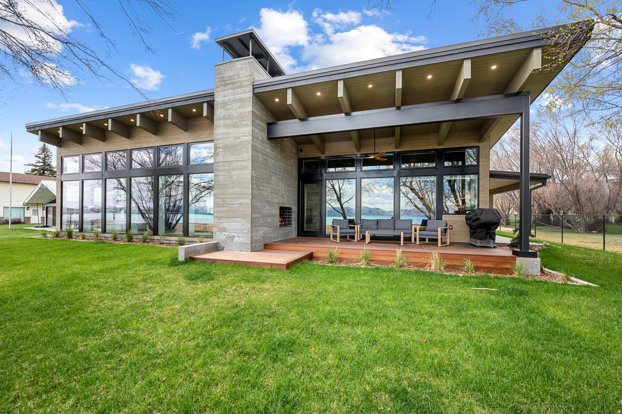 Where modern design meets refined lakefront living on the shores of Bear Lake-this is truly a one-of-a-kind property. Welcome to Edgewater, a Parade of Homes award-winning residence in Garden City, Utah. This 3-bedroom, 3-bath home offers a rare opportunity to own a truly distinctive property-blending striking architecture, resort-caliber amenities, and a seamless connection to the outdoors. Offered fully furnished, this turnkey residence allows for immediate enjoyment or effortless use as a luxury retreat. Expansive floor-to-ceiling windows frame panoramic lake views, filling the home with natural light. Vaulted beams, concrete walls, and curated contemporary finishes create a bold yet inviting aesthetic throughout. The chef's kitchen serves as the centerpiece, featuring custom cabinetry, premium appliances, and an oversized island designed for both everyday living and entertaining. The home comfortably accommodates up to 12, with a thoughtfully designed layout that balances privacy and gathering spaces. A luxurious primary suite offers a spa-inspired ensuite, while custom-built bunk rooms provide flexibility for hosting family and guests. Resort-style amenities elevate the experience at every turn. A heated indoor pool opens to a private courtyard through retractable doors, creating true indoor-outdoor living. Spa-quality bathrooms include heated floors, towel warmers, bidets, and digital shower systems. Integrated audio, multiple entertainment zones, and a garage lounge add to the home's modern convenience and appeal. Step outside to direct Bear Lake access and take in the natural beauty that defines the property. Whether enjoying quiet mornings on the water or hosting evenings by the lake, this unique property is designed to make the most of its exceptional setting. This is more than a home-it's a statement property. With award-winning design, advanced features, and a premier lakefront location, this one represents a rare blend of luxury, privacy, and architectural distinction. Please see Agent Remarks for details on Square Footage.