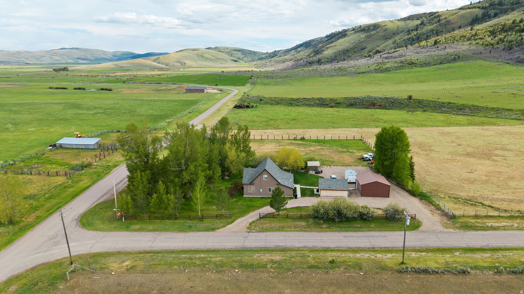 This property sits right at the mouth of Skinner Canyon, giving you direct access to miles of trails and mountain country just outside your door. The home is on 1.47 acres with a year-round ditch running through, so there's water on the land and room to keep horses or other animals. The house itself offers 3 bedrooms along with a bonus room that could easily work as a fourth.  A greenhouse and a couple of shops (both heated) are already set up, adding some real utility for anyone who likes to grow, build, or store gear. What stands out here is the setting. From the front deck you're looking at mountain views with very little traffic around, so the property keeps that quiet country feel people come to Nounan for. It's a place where you can step outside, hear the water running through the ditch, and be on a canyon trail within minutes.