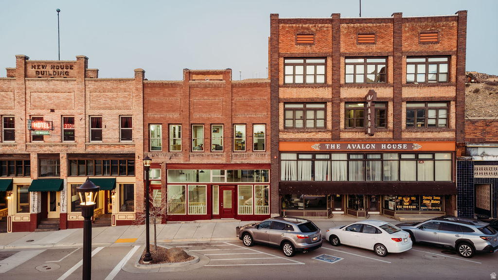 Discover this beautifully restored tri-level building on historic Helper Main Street, where thoughtful artistry meets modern functionality. This fully renovated space preserves its rich history, ensuring each detail reflects both sophistication and intention.  The main level offers over 3,000 square feet of open space, showcasing original red douglas fir flooring, 20-foot ceilings, a private bathroom, and front and back entrances, making it ideal for a gallery or retail space.  Above, the living quarters feature a private entrance, a loft-style living area and stunning views. This level includes five skylights, three bathrooms, four bedrooms-two of which are en suites. Enjoy the balcony off the primary bedroom and private entrance facing the Price River and views of balance rock. All countertops throughout are hand crafted from the building's reclaimed materials. You'll also find ample gallery walls perfect for displaying art. Additionally, there is the convenience of a laundry room.  The lower level, with its own entrance, includes a kitchen, laundry, 3/4 bath, and plenty of open space inviting your creativity.  This historic building has all-new electrical and plumbing systems, along with modern windows, lighting, and new roof. Each floor is thoughtfully zoned with its own air conditioning and heating units, ensuring both comfort and efficiency throughout the property.  Enjoy sweeping views of the Book Cliffs and the nearby river.. This versatile space serves as an inspired studio, gallery, and  unique living area, where every corner tells a story.   Square footage figures are provided as a courtesy estimate only and were obtained from County Records. Buyer is advised to obtain an independent measurement.