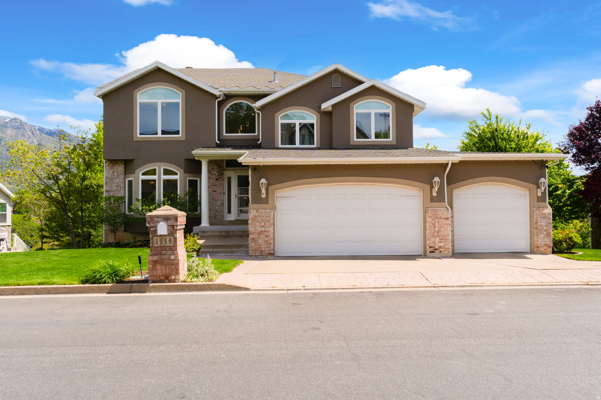 **OPEN HOUSE SAT. (5/23) 11 AM-1 PM** Homes like this are truly hard to find! Nestled in desirable East Layton, this exceptional estate offers breathtaking views of both the Wasatch Mountains and the valley. From the expansive rear deck spanning the length of the home, you can enjoy unforgettable evenings entertain guests, or simply relax while taking in the scenery. Proudly owned and meticulously maintained by the original owner, this home showcases quality and care throughout. The gourmet kitchen is a chef's dream featuring high-end stainless steel appliances, granite countertops, a large center island, abundant cabinetry, and generous prep space. Just off the kitchen, the spacious great room with fireplace creates the perfect gathering place for family and friends. Recent upgrades include new mechanical systems, permanent holiday, lighting, new windows, newer flooring, paint, and updated lighting, giving the home a fresh and modern feel. The functional floor plan offers elegant formal living and dining spaces, including a large sitting room ideal for a grand piano or additional entertaining area. Upstairs, an open walkway overlooks the grand entryway below, creating a bright and open atmosphere. The private owner's suite is set on its own level just above the secondary bedrooms and laundry room, offering a true retreat complete with vaulted ceilings, a two-sided fireplace, separate tub and shower, and a spacious walk-in closet. The fully finished basement features impressive 10-foot ceilings, a private kitchenette, separate entrance, two additional bedrooms, and a full bathroom-perfect for guests, multi-generational living, or adult children. Step outside to the covered patio where you can unwind in your future hot tub while enjoying mountain views and the peaceful surroundings. The park-like backyard provides your own private sanctuary, and the detached storage garage offers ideal space for lawn equipment, tools, and extra storage. Located on a quiet street just off Highway 193, this home offers quick freeway access, nearby foothill recreation, and dedicated community walking trails leading directly to Hobbs Pond. You are centrally located 20 minutes to downtown Salt Lake, or 20 minutes to Snowbasin ski resort. This is a rare opportunity to own a beautifully cared-for home in one of Layton's most sought-after locations. You will not want to miss this one!