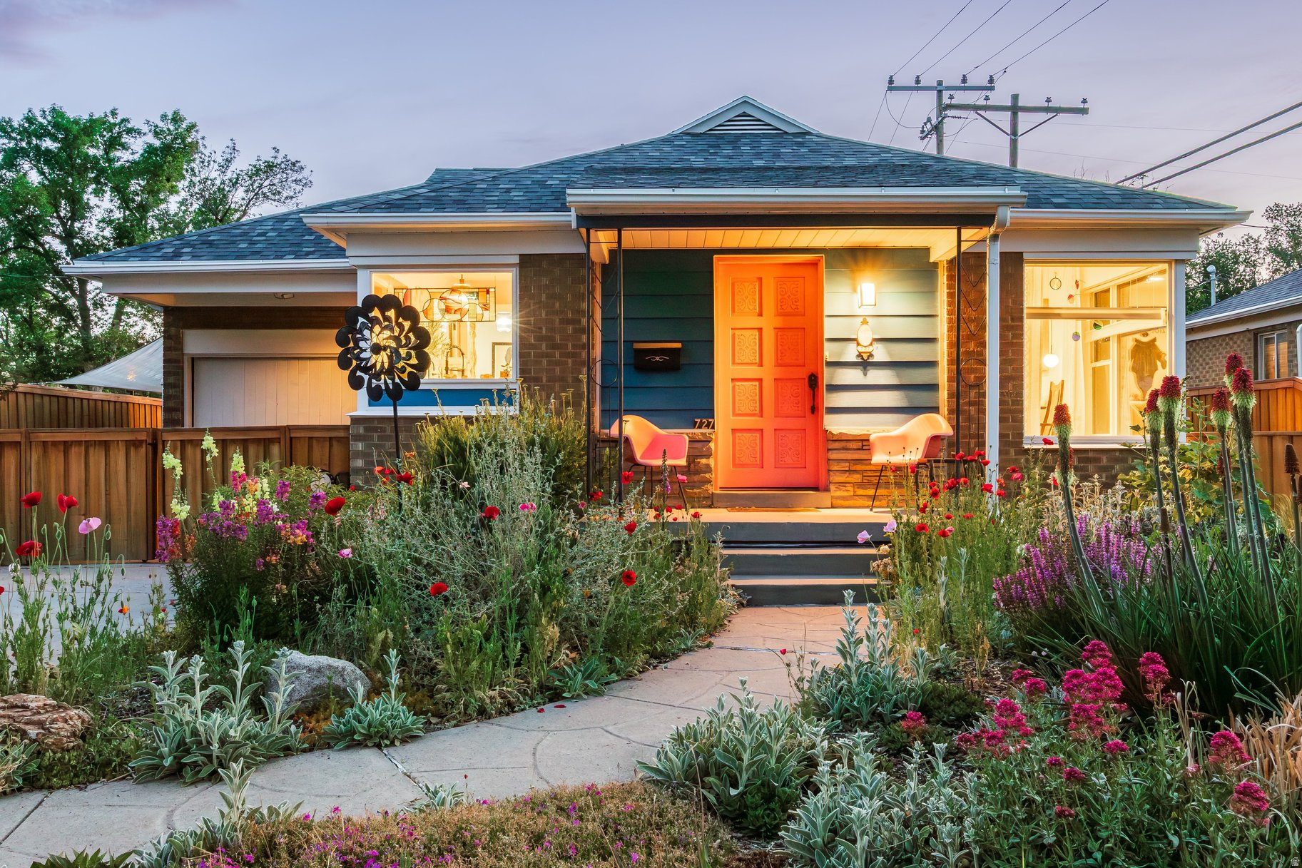 **Multiple Offers Received** Tucked into the heart of the coveted Rose Park neighborhood, this artfully reimagined bungalow blends vibrant design with thoughtful functionality at every turn. From the moment you step inside, abundant natural light pours across warm wood floors, illuminating curated details and cheerful hues that make the home feel both elevated and inviting. The open-concept kitchen has been completely transformed into a stunning gathering space, framed by sunbeams from a charming corner window. Highlights include a spacious island/bar, striking tuxedo backsplash detail, generous cabinetry, and high-end appliances-perfect for everyday living and effortless entertaining. French doors off the primary bedroom open to a dreamy covered patio with skylights overhead, creating the ideal setting for shaded summer barbecues, morning coffee, or cozy evenings outdoors. A serene main-floor bath features calming tones and timeless finishes, while a second bedroom completes the upper level. Downstairs, the thoughtful remodel continues with impressive ceiling height, abundant natural light, and exceptional storage throughout. The lower level offers a third egress bedroom, stylish 3/4 bath, spacious second living area, and dedicated laundry room-providing flexibility for guests, work-from-home living, or additional retreat space. Outside, the lush front and back yards are a gardener's delight, bursting with multi-colored perennial blooms, mature trees, and multiple raised garden beds ready for fresh vegetables and seasonal harvests. Enjoy all the perks of this bike-friendly neighborhood with easy access to local parks, community green spaces, the Jordan River Parkway trail system, downtown Salt Lake City, and quick routes to world-class mountain recreation.