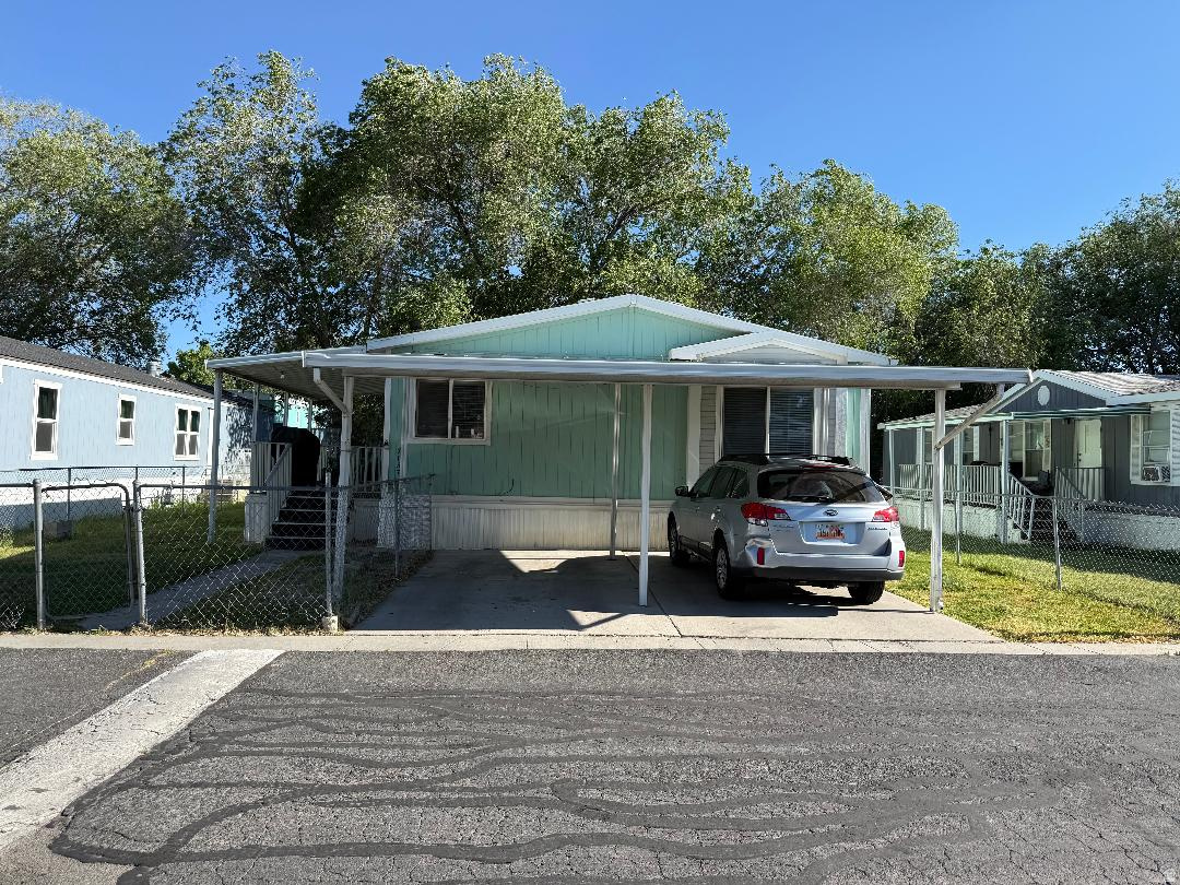 This newly listed double-wide home offers 3 spacious bedrooms and 2.5 bathrooms, featuring a well-appointed primary suite with a garden tub and separate shower. The open-concept layout includes a functional kitchen with an adjacent dining area, along with a full laundry room-providing everything needed for comfortable, everyday living. The interior features a mix of laminate and carpet flooring, complemented by forced air heating for year-round comfort. Two covered parking spaces add convenience and protection from the elements. Ideally located within the Granite School District, the home is just minutes from local schools, shopping centers, and all the amenities West Valley has to offer. Easy access to the 201 Highway and Mountain View Corridor ensures a convenient commute.