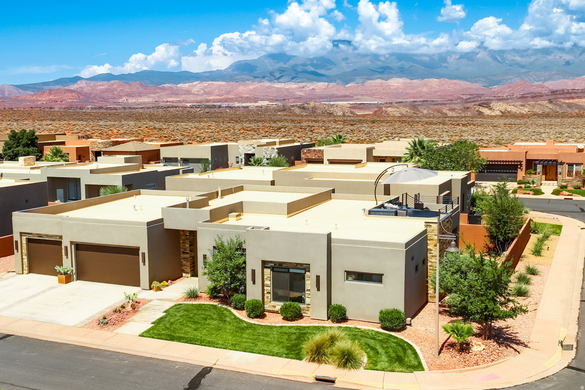 Experience the ultimate Southern Utah lifestyle in the prestigious Sand Hollow Resort, where championship golf, resort amenities, lake recreation, and endless desert adventure are all at your doorstep. Just five minutes from Sand Hollow Reservoir and the iconic Sand Mountain dunes, this beautifully appointed 4-bedroom, 4-bathroom home offers an exceptional blend of luxury, comfort, and outdoor living. Spend your mornings on the golf course, afternoons at the lake, and evenings taking in breathtaking red rock sunsets from your private rooftop patio.  Designed for both privacy and entertaining, each bedroom features its own en suite bathroom and walk-in closet. Professionally designed with upscale finishes throughout, the home showcases custom ceiling beams, elegant tile flooring, new carpet, designer lighting, and ceiling fans in every bedroom.  Outdoor living is where this home truly shines. Featuring four separate patios and a private hot tub, there is no shortage of space to gather with friends and family or enjoy quiet moments surrounded by Southern Utah's breathtaking scenery. The spectacular rooftop patio offers panoramic views of the surrounding red rocks and desert landscape, creating the perfect backdrop for sunset gatherings, stargazing, and unforgettable evenings.   Additional features include a spacious 3-car garage with a dedicated 220V EV charging outlet, abundant storage, three-zone air conditioning, and a whole-home humidifier for year-round comfort.   Ownership at Sand Hollow Resort includes access to exceptional resort amenities, including multiple pools, hot tubs, pickleball courts, a fitness center, clubhouse, and The Grille at Sand Hollow.  Homeowners also enjoy discounted golf rates and preferred pricing on ATV, boat, and watercraft rentals, making it easy to take full advantage of everything the area has to offer.   The HOA handles front and backyard landscaping as well as exterior maintenance, providing a true lock-and-leave lifestyle ideal for full-time residents, second-home owners, or investors.   With Zion National Park just 30 minutes away, Zion Canyon Hot Springs only 20 minutes away, and convenient access to Bryce Canyon National Park, this home offers a rare opportunity to enjoy luxury resort living in the heart of Southern Utah's most sought-after recreational destination.  Every day feels like a vacation when your backyard includes championship golf, a world-class reservoir, endless sand dunes, and some of the most spectacular landscapes in the American Southwest.   Square footage figures are provided as a courtesy estimate only and were obtained from county records. Buyer is advised to obtain an independent measurement.