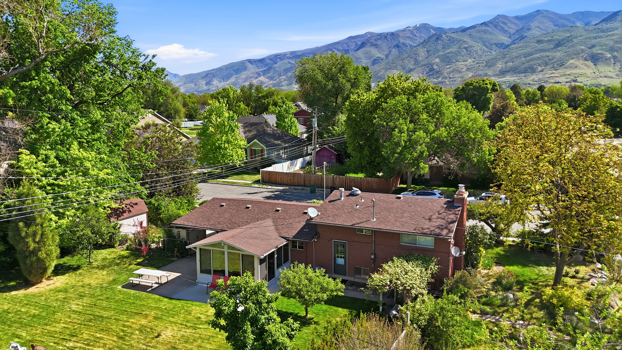 Situated on a well-maintained corner lot in the heart of Kaysville, this charming, well maintained and loved multi-level home offers mountain views and the perfect blend of small-town living with everyday convenience. You're going to love entertaining in the Sunroom!  The fully fenced yard gives privacy and space to enjoy mature apple and pear trees, an RV pad for additional parking or recreational storage, plus two sheds & abundant basement storage for all your tools, hobbies, and seasonal needs. Thoughtfully cared for, this home features a new dishwasher (2025), 3-year-old water heater, and a roof replaced in 2013 for added peace of mind. Connected to Haights Creek secondary water, the property offers practical outdoor benefits as well. With functional outdoor space, and comfortable living areas, this home combines charm and versatility. Enjoy being close to local amenities, schools, and parks while taking in the beautiful mountain surroundings. Just a short walking distance to Kaysville town square! Square footage figures are provided as a courtesy estimate only and were obtained from county .  Buyer is advised to obtain an independent measurement.
