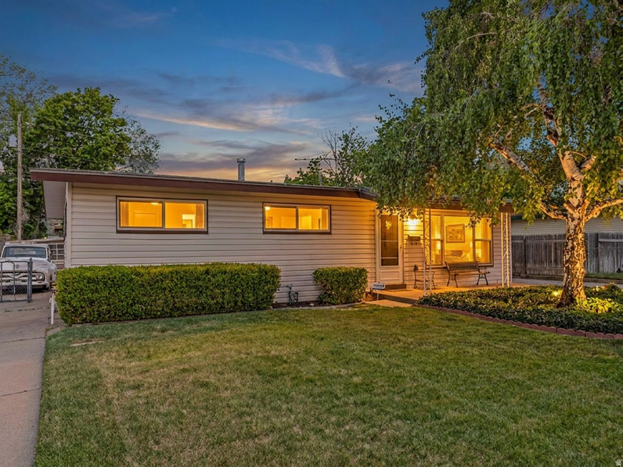 Pristine and well maintained, this 3 bedroom, 1 bath Sunset home offers charm, comfort, and an impressive amount of flexible indoor and outdoor space. A large covered front porch creates a welcoming first impression, while the expansive fully enclosed patio/sunroom off the kitchen provides a standout bonus living area to enjoy in every season. Surrounded by windows and equipped with screens, this space features three exterior doors and offers a bright, versatile setting for relaxing, entertaining, or simply enjoying the backyard views. Inside, you'll appreciate the abundant storage throughout the home, with tons of cupboards, cabinets, and functional space. Outside, you'll find a fully fenced yard with automatic sprinklers, RV parking, two separate driveways, a 1-car attached garage, and an additional carport. A detached shop with power and a wood-burning stove adds even more utility and potential, along with two additional storage sheds. The home is also equipped with central air for added comfort.