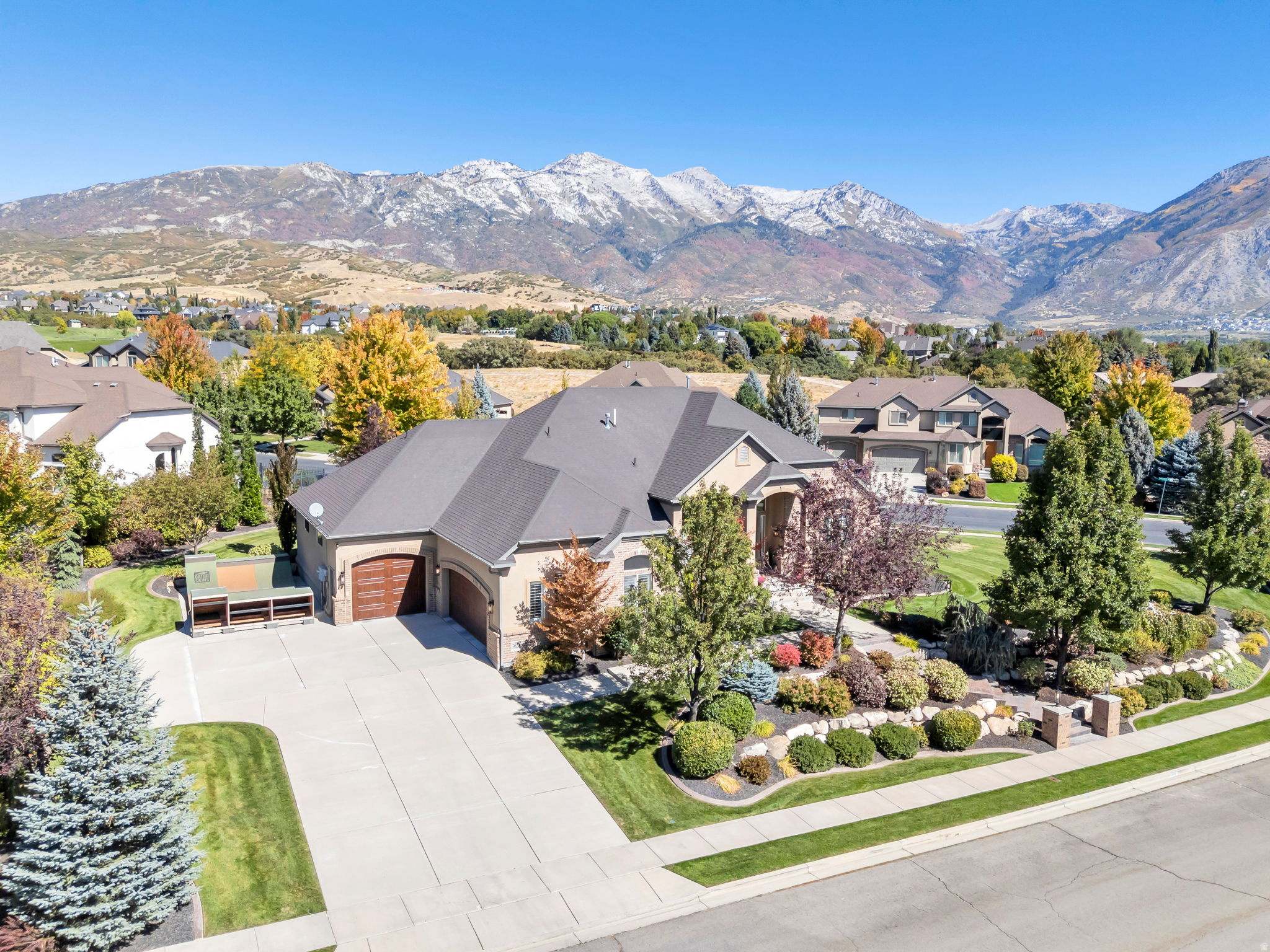This stunning and spacious rambler, located in the coveted Beacon Hill neighborhood of Highland, merges elegance and convenience. This home has been thoughtfully renovated throughout and offers refined mainfloor living with genuine hardwood floors, abundant natural light, and expansive windows showcasing extraordinary mountain views. The main floor features a spacious kitchen with custom cabinetry, quartz countertops, and other high-end finishes, as well as a massive great room with vaulted ceilings and a beautiful twoway fireplace. The walkout basement is a home within a home. It would make a great mother in law apartment. It adds exceptional flexibility with a full second kitchen, a large family room, and extensive storage.  With three bedrooms and two full-size bathrooms, the basement is ideal for guests, multigenerational living, or hobbies. The professionally-landscaped grounds feature two soothing water features, a front porch, a covered back deck, and a patio with a gas firepit, creating a peaceful outdoor oasis. In addition to significant interior storage, the property features a three-car garage (including an extra-deep third-car bay) and a wide RV pad. Outdoor enthusiasts will appreciate the close proximity to American Fork Canyon, Mt. Timpanogos, and the scenic Alpine Loop. Pride of ownership and thoughtful design are evident in this exceptional Highland property. Most of the furnishings in the home may be negotiable for buyers looking to upsize or transition with ease.