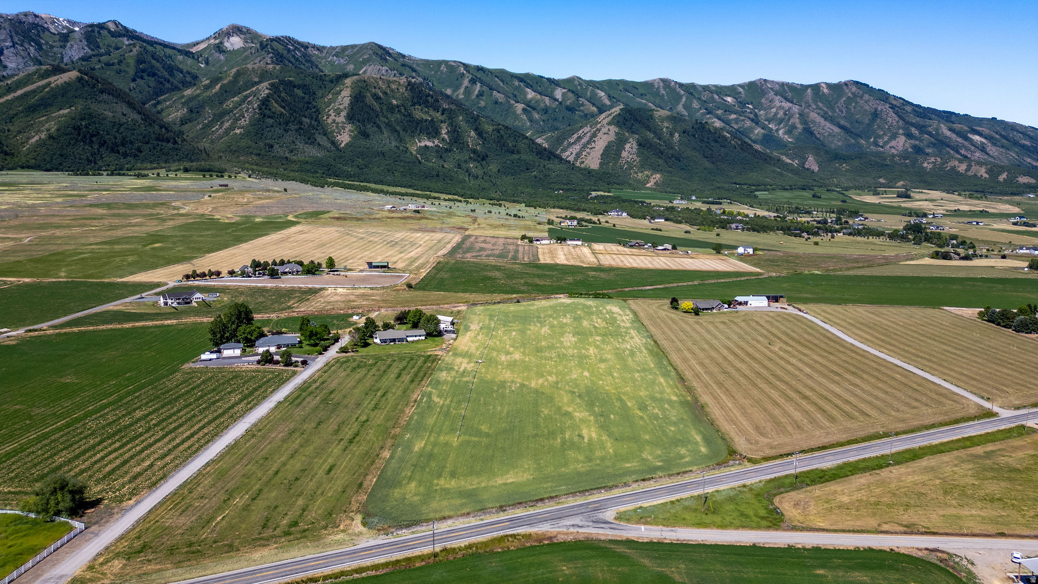Hard-to-find 11.5-acre parcel in Wellsville with views of the Beautiful Wellsville Mountains and Cache Valley. Build a home and enjoy the space for horses, livestock, hay production, or other agricultural uses. The property includes 23 Wellsville-Mendon irrigation shares and offers easy access from Highway 23. Year-round access and plenty of room to enjoy country living while being just a short drive from town. Buyer to verify all information, utilities, and development requirements.  PROPERTY BEING FARMED PLEASE DON'T DRIVE ON FIELD.