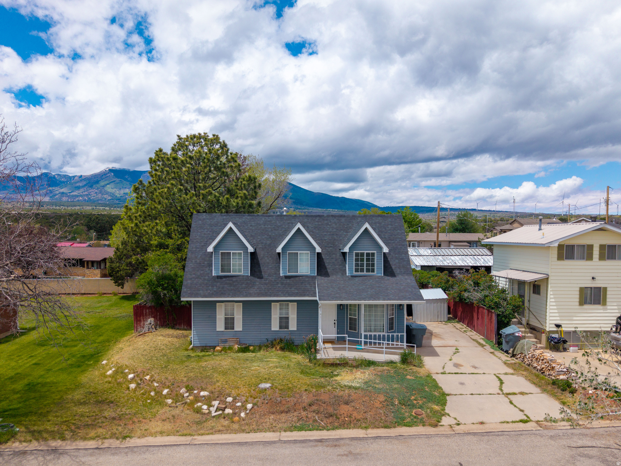 Located in a quiet Monticello neighborhood with views of the Blue Mountains, this unique 4-bedroom, 3-bathroom home has many special features. The entry living room has lots of natural light with two story ceilings, there's a wood-burning stove in the back family room/kitchen area, and it is ADA-accessible with the front ramp entry. The functional layout includes two bedrooms and a bathroom on the main level, while the upper level has a spacious master suite with a clawfoot tub, lots of natural light, and a bedroom with a lookout over the living area. The property offers exceptional storage including a large attic, a driveway shed, and a second shed on a permanent foundation with electricity. Enjoy the mature pine tree in the backyard as well as the apple and apricot trees.