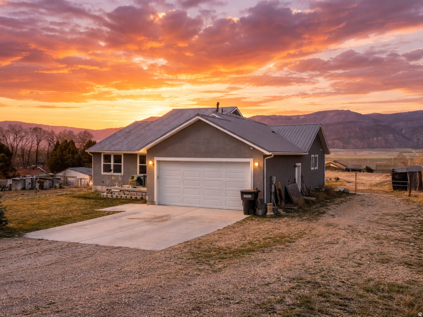 Modern comfort meets wide-open living in this stunning property surrounded by breathtaking mountain views and glowing sunset skies. Designed with a clean, contemporary feel, this home offers the perfect escape from the city while still maintaining a refined, updated style.  Set on .77 acres, you'll have the freedom to create the lifestyle you've been looking for. Whether it's riding, exploring nearby off-roading trails, or simply unwinding at the end of the day as the sun sets over the mountains, this property delivers a rare combination of functionality and freedom.  This 2023 home is built for both durability and flexibility, featuring a metal roof for long-term peace of mind, a spacious 30 ft shed in the back for storage, projects, or toys, and a basement with room to grow, giving you the opportunity to expand and add value over time.  This is where modern living and small-town lifestyle truly come together.  Ask about getting an included 1% rate buy-down for your first year! Square footage figures and all other information are provided as a courtesy estimate only. Buyer is advised to obtain an independent measurement and verification. Agent is related to the Seller.