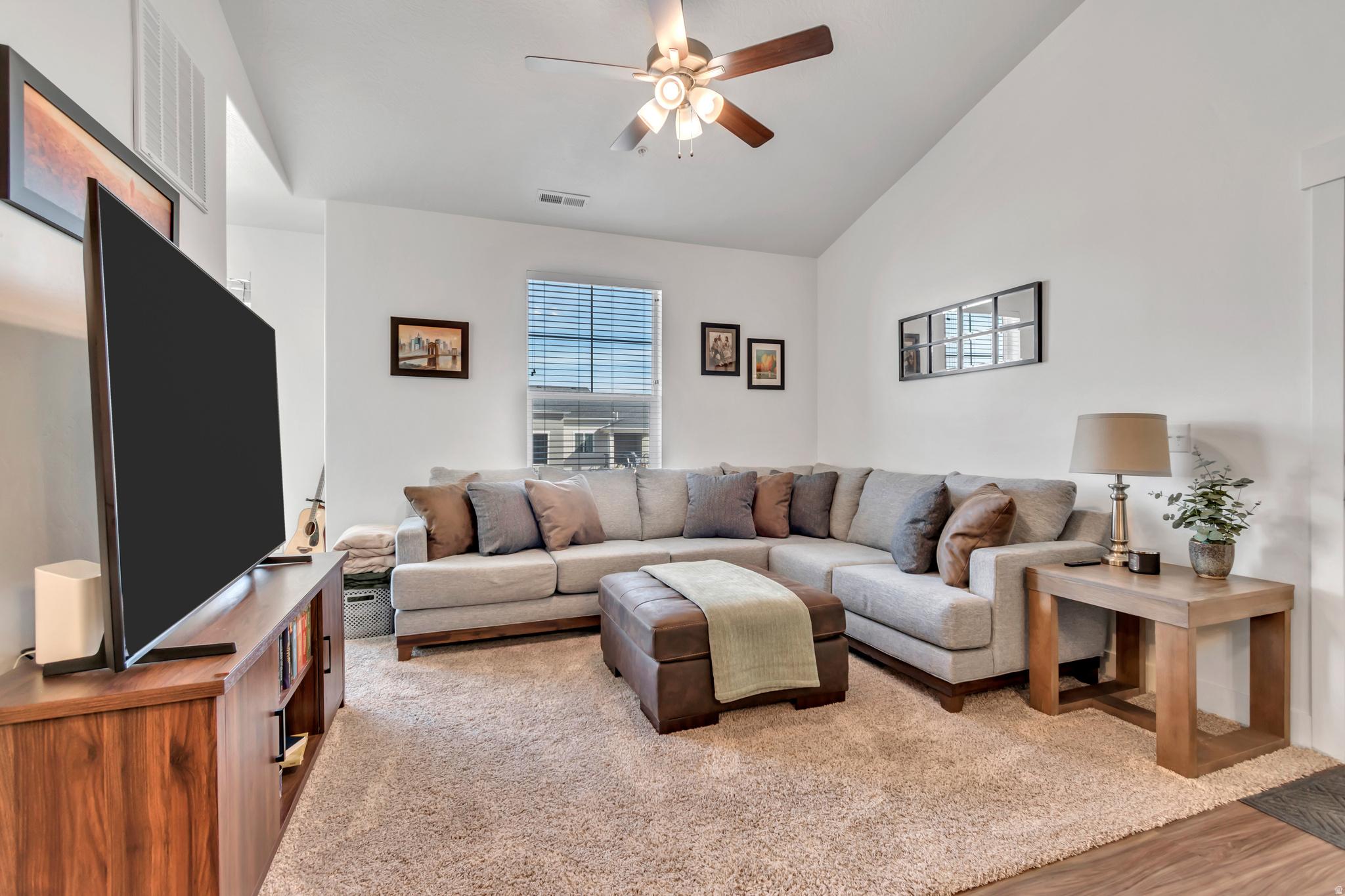 Welcome to your move-in-ready sanctuary in the heart of Lehi. Built in 2022, this stunning top-level condo in the Gardner project offers 1,349 square feet of modern, open-concept living. As you step inside, you are greeted by expansive vaulted ceilings and high-end finishes, including sleek quartz countertops and durable laminate flooring that flow seamlessly through the main living areas. The thoughtfully designed layout features three spacious bedrooms and two bathrooms, highlighted by a private primary suite complete with a generous walk-in closet. Perfectly situated to capture breathtaking mountain and valley views, this home also comes equipped with wired Ethernet ports to keep you connected in the center of Silicon Slopes.  Life at Gardner is as convenient as it is comfortable. Your monthly HOA fee takes the stress out of homeownership by covering water, sewer, trash, and snow removal, while providing access to premium community amenities. Spend your summers lounging by the pool, stay active in the fully equipped gym and clubhouse, or enjoy the on-site playground and park. This property includes an attached one-car garage with additional driveway parking and is ideally located within the Alpine School District, just minutes from world-class shopping and dining.  Square footage figures are provided as a courtesy estimate only and were obtained from County Records.  Buyer is advised to obtain an independent measurement. Buyer and agent to verify all information.