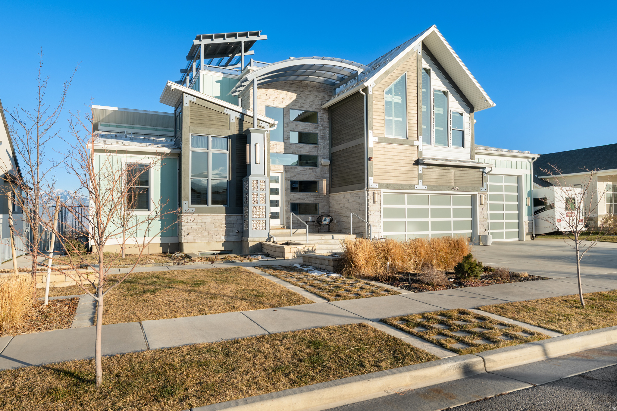 Experience elevated living in this stunning custom built luxury home in Herriman's coveted Range East community. Designed with both entertaining and everyday comfort in mind, this expansive residence blends modern architecture with thoughtful, high-end finishes throughout. Soaring ceilings, abundant natural light, and dramatic design elements including a striking glass staircase and spiral stair feature-create a seamless flow across multiple levels. The heart of the home is a chef-inspired kitchen with quartz countertops, premium appliances, double ovens, and generous gathering space perfect for hosting or daily living. Retreat to the primary suite conveniently located on the main level, offering a spa-like bathroom and walk-in closet. Additional flexible spaces include a private office, loft, exercise room, and an immersive home theater delivering a true cinematic experience, full surround sound . The fully finished daylight basement with walkout access expands the home's versatility-ideal for recreation, guests, or multigenerational living. Step outside to a beautifully landscaped backyard oasis featuring a heated in-ground pool, hot tub, outdoor shower and recessed fire pit. Below the basement level, under the garage is a suspended slab garage floor which allows for a giant room for all kinds of entertaining and play. Multiple patio areas designed for relaxation and entertaining. One of the home's most impressive highlights is the rooftop deck, complete with a private hot tub and breathtaking mountain views perfect for sunset evenings or stargazing under Utah's open sky. Bluetooth audio system throughout the home and in each individual room. Security system watches over the entire home, inside and out! With a spacious 4-car garage, extra height and depth for storage, smart-home features, and exceptional indoor-outdoor living, this home offers luxury, comfort, and endless possibilities. Conveniently located near schools, parks, and amenities, this is a rare opportunity to own a truly one-of-a-kind property.  Luxury. Lifestyle. Location. This home has it all. This home is absolutely perfect for any of you influencers that want a place to create content, in privacy!