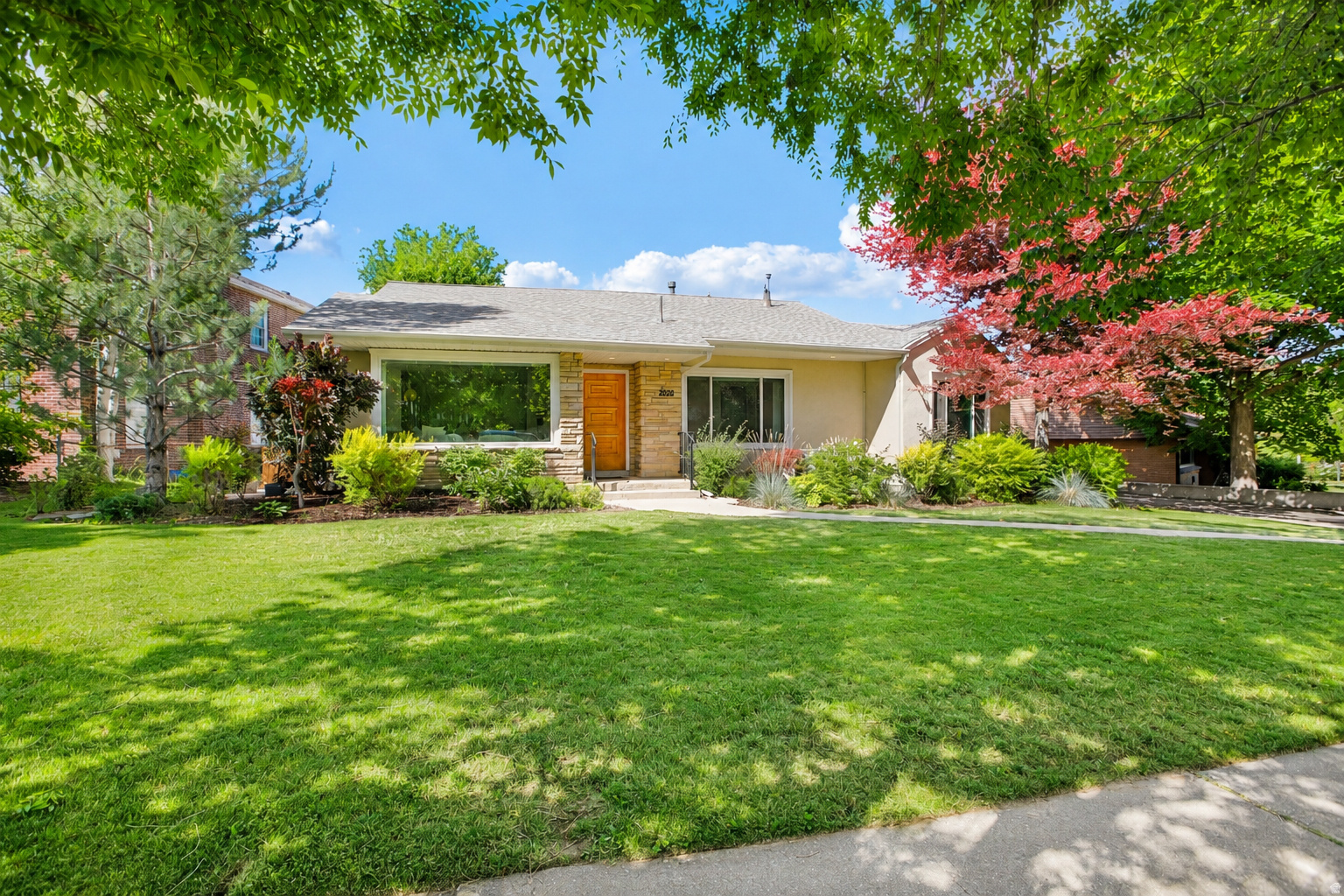 Immaculately maintained home in an amazing neighborhood of Yalecrest.  Open layout with hardwood floors, new large double paned windows, gas fireplace, and a walk out deck. The large updated kitchen has granite counter tops, stainless appliances, an island with bar stool seating, and plenty of cabinet space. Spacious living room in the basement with bonus bedroom, storage, and an enormous laundry room with a wall of cabinets.  Rest easy knowing the big things have been replaced or updated: Roof replacement in 2024, Solar Panels (7.3 kW system with 24 panels) installed 2018, tankless water heater and under sink RO filter installed in 2024. New dual pane energy efficient windows installed 2024, new a/c condenser 2021.