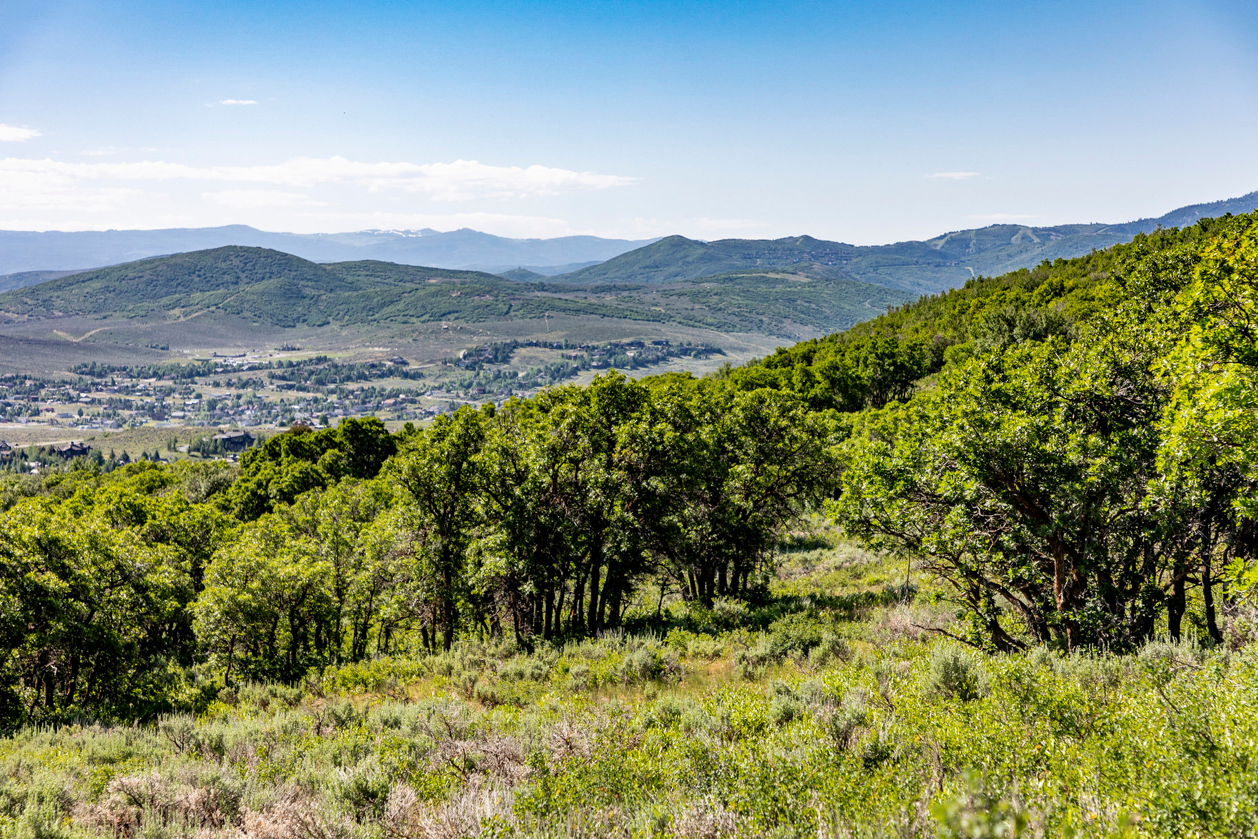 This 13+ acre Ranches at The Preserve lot offers incredible privacy and a gentle downhill slope to build up to four structures with expansive Uinta Mountain range views and adjacent to Glenwild Golf Course & Spa. Set amongst the gamble oak trees, this lot allows an owner to choose the 50,000 sq. ft. building envelope and build a 5,000-17,500 square foot primary residence, a caretaker cottage, a guest house and a barn structure. Horses are permitted with approval from the HOA. Ranches at the Preserve is an exclusive gated residential community in Park City just minutes from the retail and dining options at Kimball Junction, including Whole Foods, minutes to skiing at Park City and Deer Valley resorts, and is located within the Park City School District. Additionally, the community is adjacent to the Glenwild Golf Club & Spa, Utah's #1 rated golf course by Golf Digest Magazine that offers golf, tennis, pickle ball, dining, fitness center, spa social events and more. Memberships are available for purchase separately. The seller has preliminary plans from the award-winning design firm, Lake Flato, which can be shared with a buyer. Build your mountain escape and begin your dream Park City lifestyle! Lot size source is county records, buyer to verify.