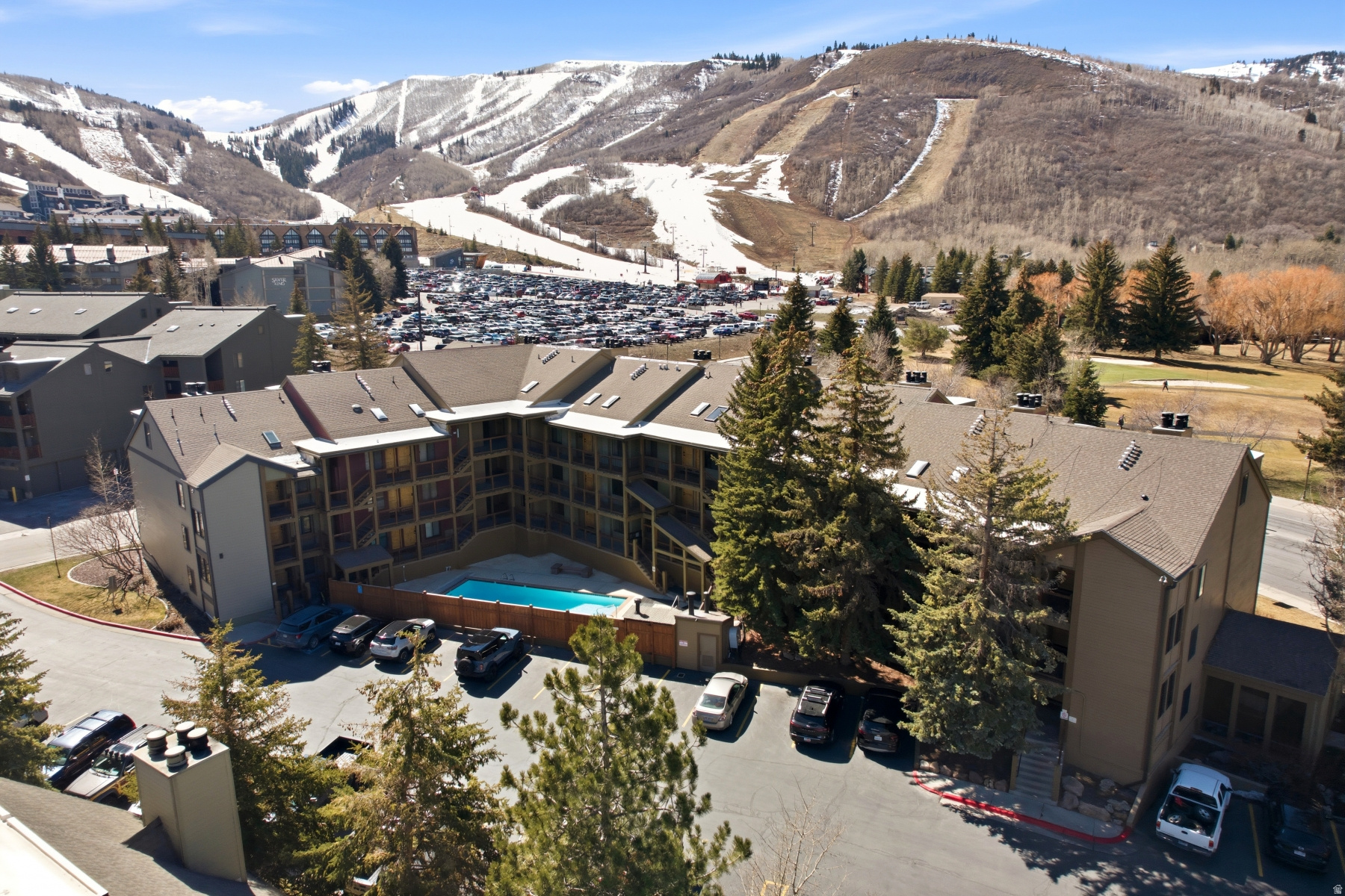 Top-floor in Snowcrest, steps from Park City Mountain's First Time and Eagle chair lifts and the 16th green of Park City Golf Course. Walkable to Main Street or hop the free Park City Transit two minutes away. The vaulted great room features wide-plank LVP flooring, a wood-burning fireplace with custom mantle, and an updated kitchen with stainless appliances. The open loft is set up as a second bedroom, with built-in wardrobe storage. Renovated bathroom, fresh paint, new blinds, and quality furnishings throughout. Community amenities include a heated pool, oversized hot tub, and ski storage. The location and turnkey condition make it equally compelling as a personal retreat or income-producing property.