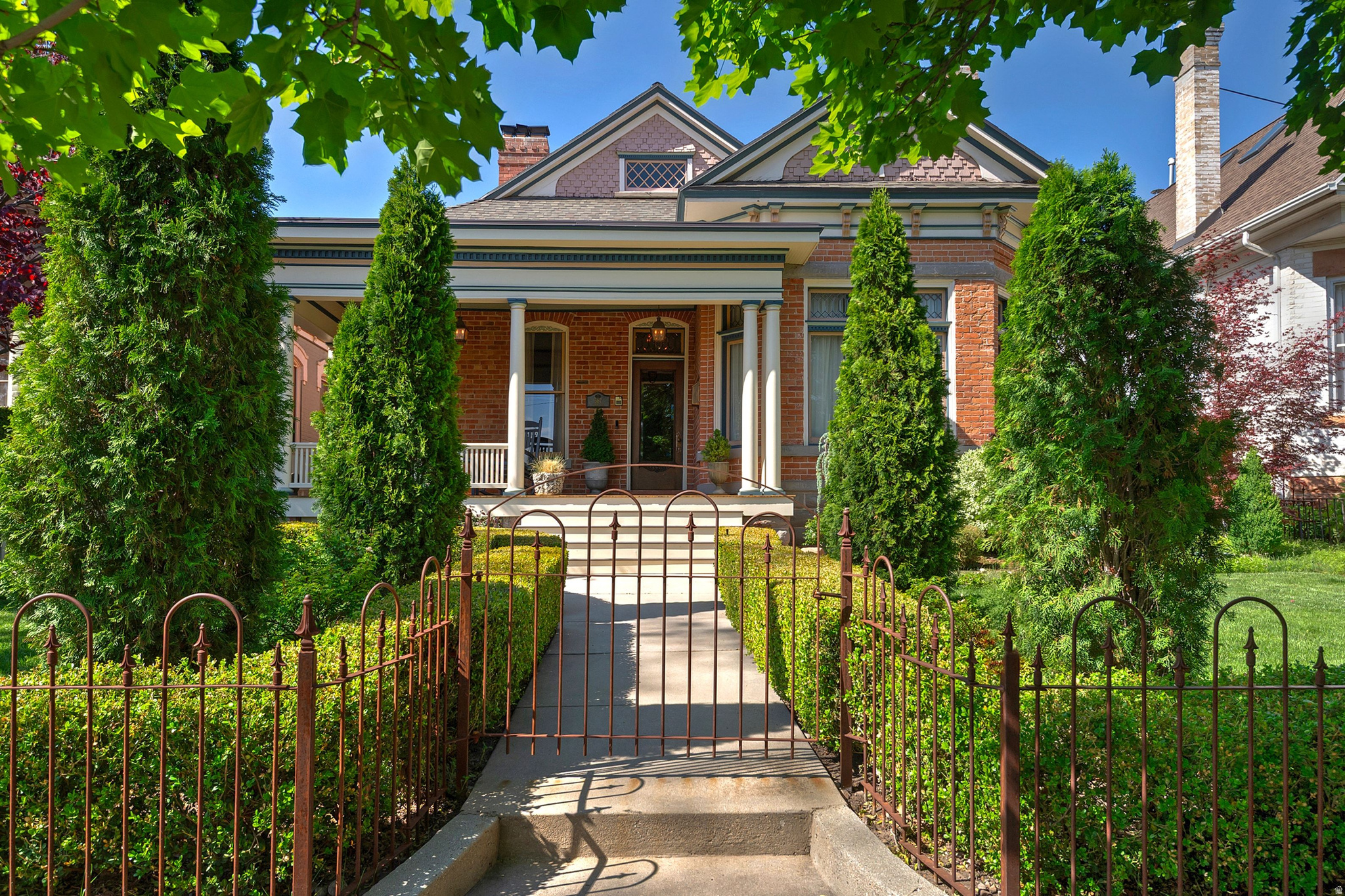 A rare find! Located in the heart of Salt Lake City's Avenues Historic District and recognized on the Historic Register, this beautifully maintained Victorian Eclectic home blends timeless character with thoughtful modern updates. Originally built in 1890 for the family of William Romney, a prominent businessman associated with ZCMI, the home has been cared for by only three owners throughout its history. Original architectural details, restored hardwood floors, stained glass, designer wallpaper, and curated lighting create a warm, collected feel throughout the home. Included with the property are a curated chandelier collection and stained glass pieces sourced over many years. Recent updates include large basement windows that bring in natural light and give the lower level a fresh, modern feel.The updated kitchen features professional-grade appliances, a pantry, and opens to a cozy hearth room with a gas fireplace. The main-level features a versatile layout including a primary suite with a marble bath and walk-in closet, an additional bedroom, laundry room, and dining room. Downstairs offers two additional bedrooms, family room space, and a tucked-away den would be ideal for a wine cellar, office, or creative space. An additional feature is the unfinished attic space (not included in the square footage), offering future potential for a bedroom suite, office, studio, or entertaining area. Outside, European-inspired gardens, fountains, side veranda, and the perfectly restored front porch create inviting outdoor living spaces. A rare two-car garage with alley access adds convenience hard to find in the Avenues. For buyers looking for a historic Avenues home with the major updates already completed, this property offers a rare combination of character, functionality, and location just minutes from downtown, City Creek Canyon, and foothill trails.