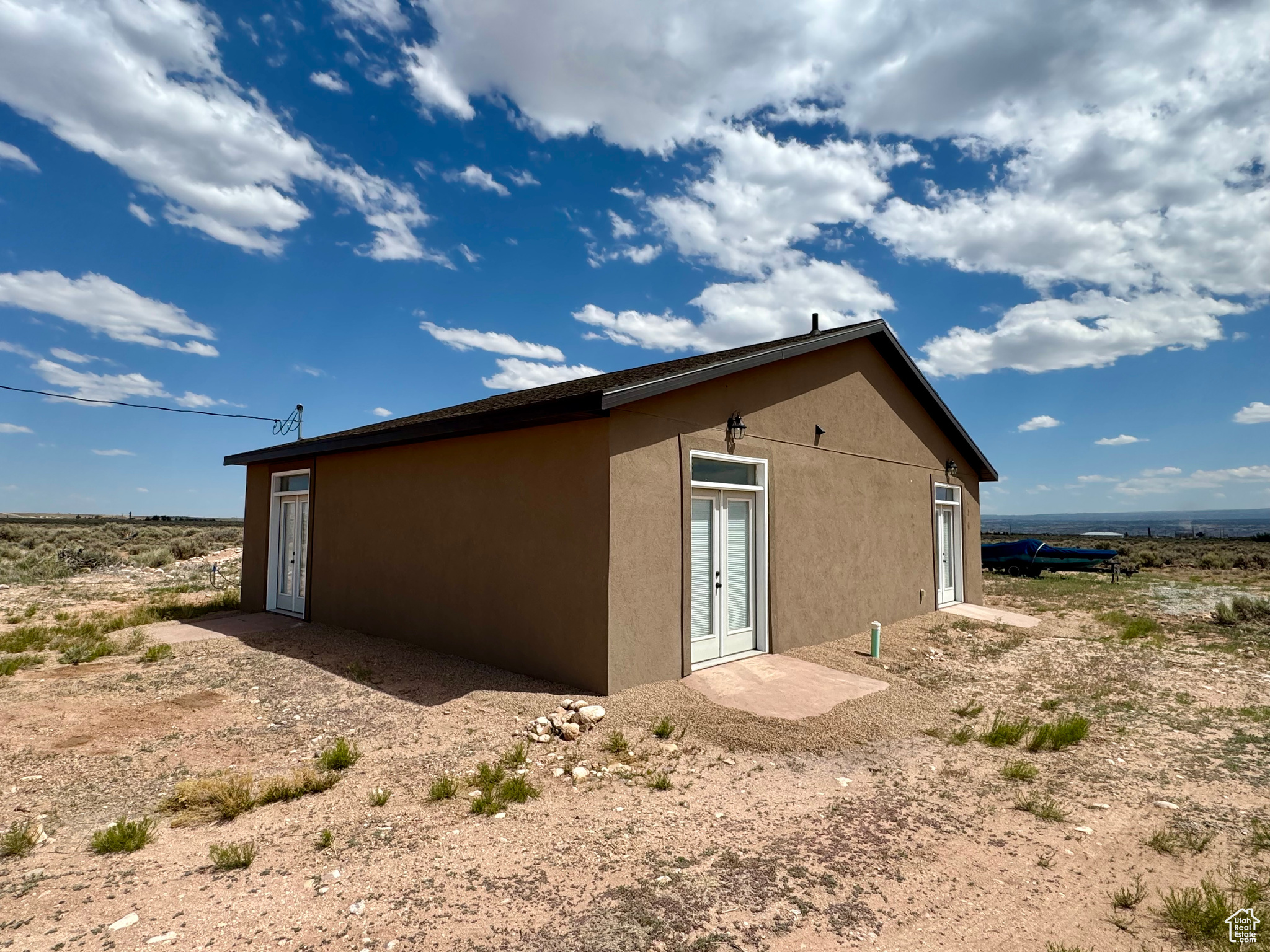 Come see this unique and highly efficient home on 10 acres.  Home has never been lived in and the interior was completed in 2025.  The walls are insulated concrete with a stucco exterior giving this home a very high R-value.  The open floor plan with 9' ceilings make this home feel very spacious.  The kitchen includes granite countertops and a pantry for additional storage.  Each room has French doors giving great access and ample natural light.  The two half baths share access to the one shower/tub making a very efficient use of space.  There is also a  12'x35' concrete foundation with stem wall that was poured for a green house.  The large 10 acre lot gives you plenty space and could possibly be subdivided with county approval.  Square footage figures are provided as a courtesy estimate only. Buyer is advised to obtain an independent measurement.