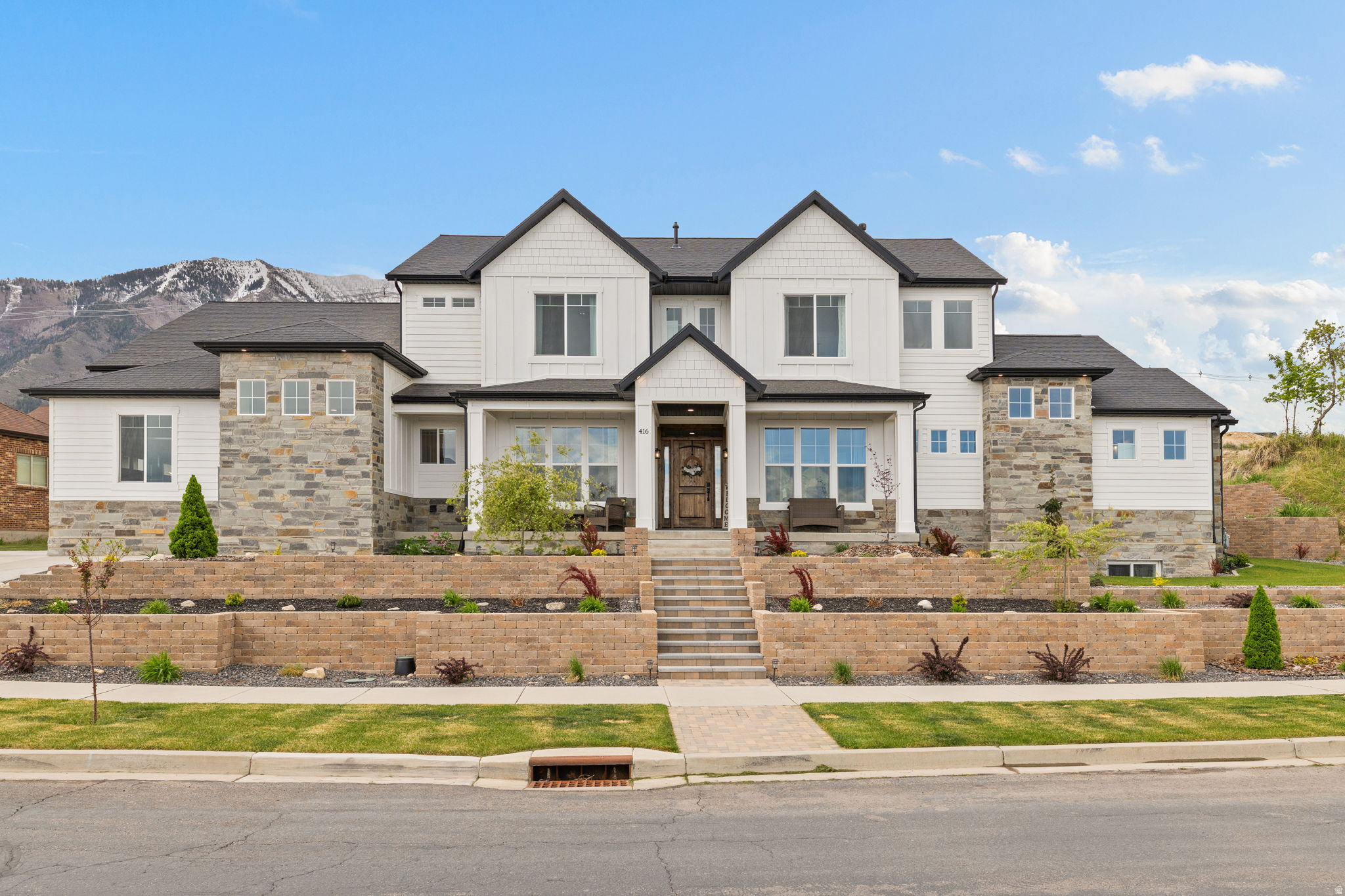 Welcome to one of Salem's most exceptional custom-built estates, where thoughtful design, elevated finishes, and expansive living come together to create a home that is as functional as it is unforgettable. From the moment you arrive, the curb appeal sets the tone. A welcoming front porch frames stunning mountain views, creating the perfect setting for slow mornings and quiet evenings. Step inside and you're immediately greeted by natural light, soaring ceilings, and a sense of openness that carries throughout the home. At the heart of it all is a true chef's kitchen designed to impress and perform. Featuring a large quartz island with bar seating, gas cooktop, built-in oven, farmhouse sink, custom backsplash, and floor-to-ceiling cabinetry, every detail has been carefully selected. The oversized butler's pantry adds both convenience and storage, while the semi-formal dining area and open flow into the main living space make this home ideal for hosting and everyday living alike. The adjacent family room showcases a striking floor-to-ceiling fireplace with custom rockwork and floating shelves, creating a warm, refined focal point. The main-level primary suite is a private retreat, offering generous space, abundant natural light, and a spa-like en suite complete with dual vanities, a freestanding soaking tub, and a fully custom walk-in shower with premium finishes throughout. The walk-in closet is thoughtfully designed with its own dedicated laundry space for added convenience. A main-level office, mudroom with custom built-ins, additional laundry room, and a beautifully finished half bath round out a highly functional and well-designed main floor. Upstairs, you'll find expansive living options with a second suite that lives like another primary, featuring its own walk-in closet and private bathroom. Additional bedrooms, a full bath with upscale finishes, and a large bonus room above the garage with its own climate control provide flexibility for guests, family, or work-from-home needs. The majority finished basement continues the home's elevated design, offering yet another suite with a walk-in closet and private bath, an additional bedroom, and a spacious gathering area perfect for entertaining. With plumbing already in place for a future kitchen, separate access, and multiple laundry hookups, this level is primed for a mother-in-law apartment or income-producing setup. Unfinished space is ready for a future theater room, while the mechanical systems reflect true investment in quality, including dual HVAC systems, multiple water heaters, a radon system, water softener, and epoxy-finished mechanical room. Situated on a rare half-acre lot, the outdoor space delivers both function and freedom. Enjoy RV parking, a large patio stubbed for gas, and a fully usable yard with drip irrigation, mature berry plants, and room to expand. A chicken coop with concrete flooring, a large shed with loft space, and a property line that extends up the hillside create opportunities that are nearly impossible to find. From the upper portion of the lot, take in sweeping valley views, including Utah Lake, with space to create your own private overlook, fire pit, or gazebo. The oversized four-car garage offers tall ceilings, a workbench area, and a utility sink, built to handle both everyday living and recreational storage with ease. Homes of this caliber, with this level of finish, flexibility, and land, rarely come available in Salem. This is not just a home, it is a long-term lifestyle investment. Schedule your private showing before someone else secures what you'll wish you had. Information is only provided as courtesy, Buyer and Buyers agent to confirm and verify all information. Square footage figures are provided as a courtesy estimate only. Buyer is advised to obtain an independent measurement. Schools: Foothills Elementary, Valley View Middle School, Salem Jr High and Salem Hills High School