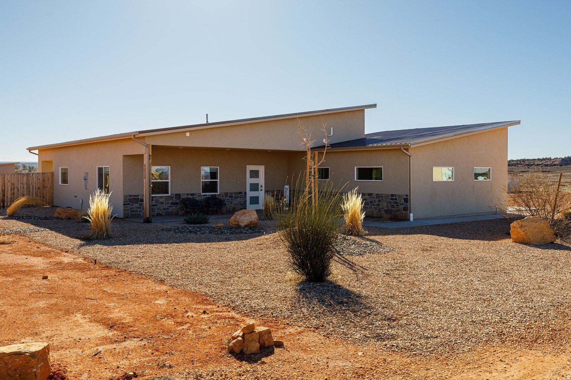 Set on 2.2 acres in scenic Kanab, this exceptional nightly-rental-approved property offers two beautifully designed homes and is being sold fully furnished with all appliances and furniture included-truly a turnkey opportunity. The main residence features 1,813 sq ft with a 2-car attached garage, vaulted ceilings, and an open-concept great room filled with natural light. Modern finishes include wide-plank flooring, sleek cabinetry, stainless appliances, and oversized windows that frame stunning red rock views.  The separate casita offers 1,232 sq ft (including a 136 sq ft loft), providing a private and comfortable space for guests, extended family, or additional rental income. Both homes feature thoughtfully designed layouts, stylish tiled bathrooms, and bright, inviting bedrooms-fully outfitted and ready for immediate use or rental.  This property enjoys access to outstanding resort-style amenities including a large outdoor swimming pool, fire pit gathering area, pickleball courts, and a swing set for kids-creating a true vacation experience for guests and owners alike. Whether used as a high-performing short-term rental, private family retreat, or hybrid investment, this property is ready to generate income from day one.  Located near Lake Powell, the East Entrance of Zion National Park, endless hiking and biking trails, numerous other parks and travel destinations and just minutes from Kanab's vibrant dining and art scene, this is a rare opportunity to own a fully furnished, income-producing retreat in one of Southern Utah's premier adventure destinations.