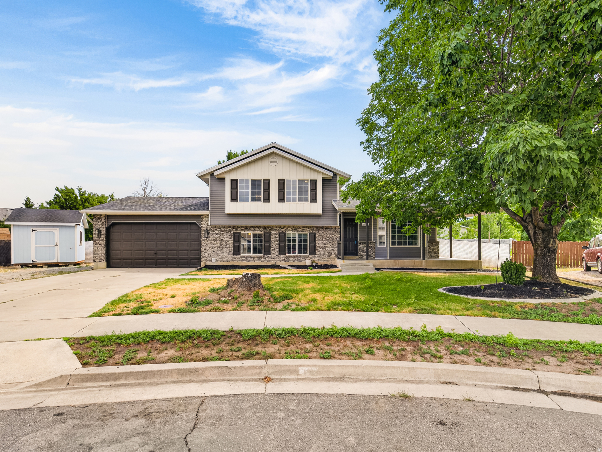 Centrally located in a cul-de-sac in a peaceful, mature neighborhood in beautiful Lehi. Close to schools, parks, churches, access to hwys for fast easy commutes, minutes to Utah Lake and historic Main Street. This home sits on a large lot- 0.4 acres- with enough space to park all your toys and RV's and still have room for more! The master suite is upstairs with a window view of the surrounding Wasatch Mountains and the large, fenced backyard. The front porch lends itself to sitting out and enjoying the cool shade from the large tree while the family plays on the front yard with minimal traffic due to it being in a cul-de-sac. There is also a large crawl space, a deep 2 car garage with sturdy wooden shelves, and a huge shed out back for even more storage! Yard comes with raised garden beds, seating around a circular fire pit to enjoy the cool Utah nights, and embedded steel poles for your very own greenhouse! The home is being offered 'As-Is' well below fair market value for such a large plot. Its a must see! You will be delightfully surprised when you walk on the property and experience the serene surroundings. *All information provided are estimates and buyers should verify all numbers to their satisfaction* Square footage figures are provided as a courtesy estimate only.  Buyer is advised to obtain an independent measurement.