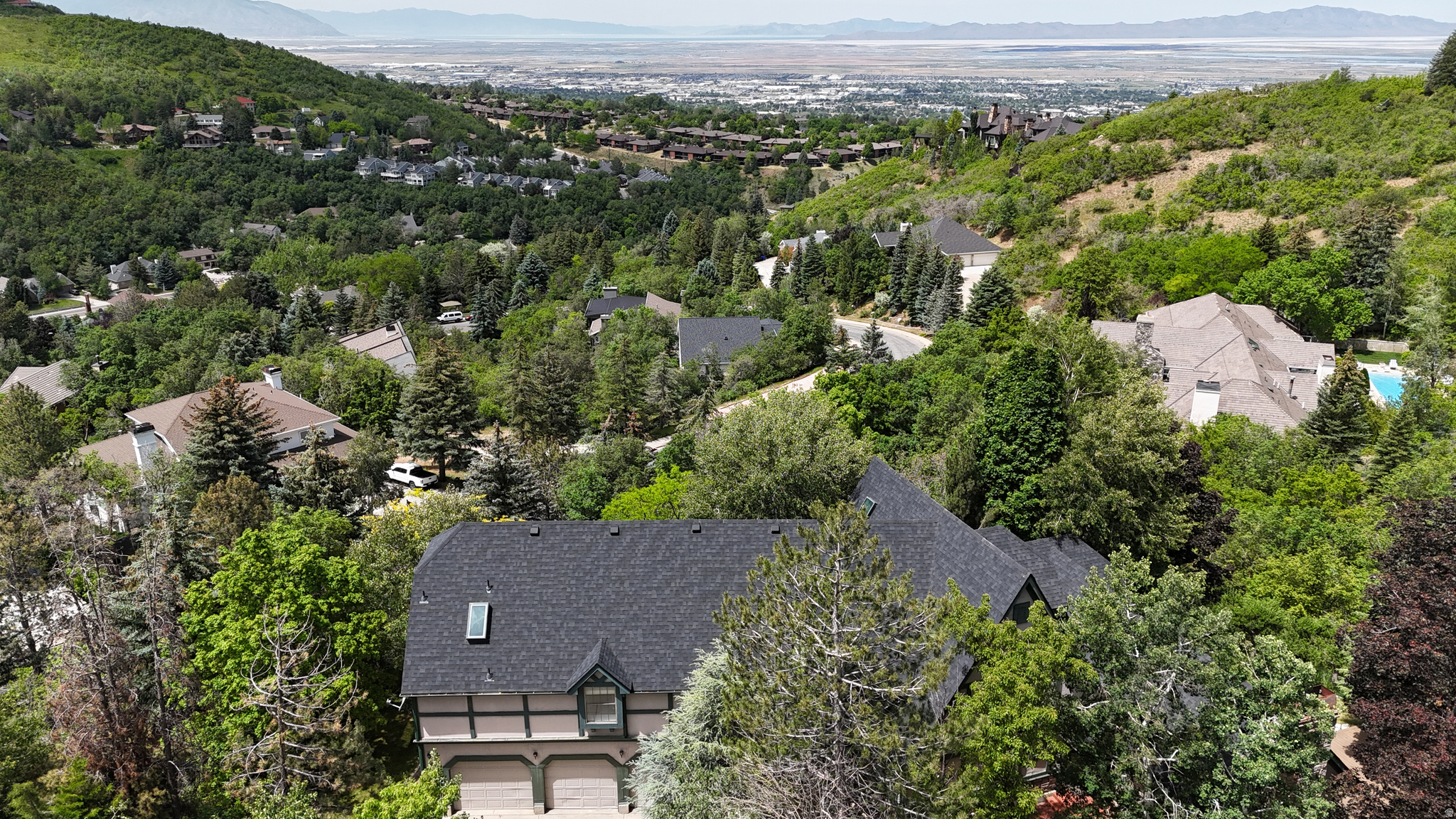 Nestled in the highly sought-after Mueller Park area, this spacious home offers a rare opportunity to own a piece of one of Northern Utah's most desirable neighborhoods. Surrounded by mature trees on a secluded lot, you'll enjoy a peaceful mountain setting where deer are frequent visitors and nature becomes part of everyday life.  With over 5,000 square feet of living space, this home provides endless possibilities for customization and renovation. The oversized garage offers exceptional room for vehicles, toys, storage, or a workshop-perfect for those who need extra space.  Outdoor enthusiasts will appreciate being just minutes from some of Utah's premier hiking and mountain biking trails, while also enjoying convenient access to the Bountiful Utah Temple and nearby amenities. Families will love the excellent schools and the strong tradition of athletic excellence at Bountiful High School, known for regularly competing for state championships across multiple sports.  While the home is ready for updates and personal touches, opportunities like this are becoming increasingly rare. Whether you're looking to create your dream home or invest in one of Bountiful's most prestigious locations, the combination of a prime Mueller Park setting, exceptional lot, abundant wildlife, and generous square footage makes this property truly special.