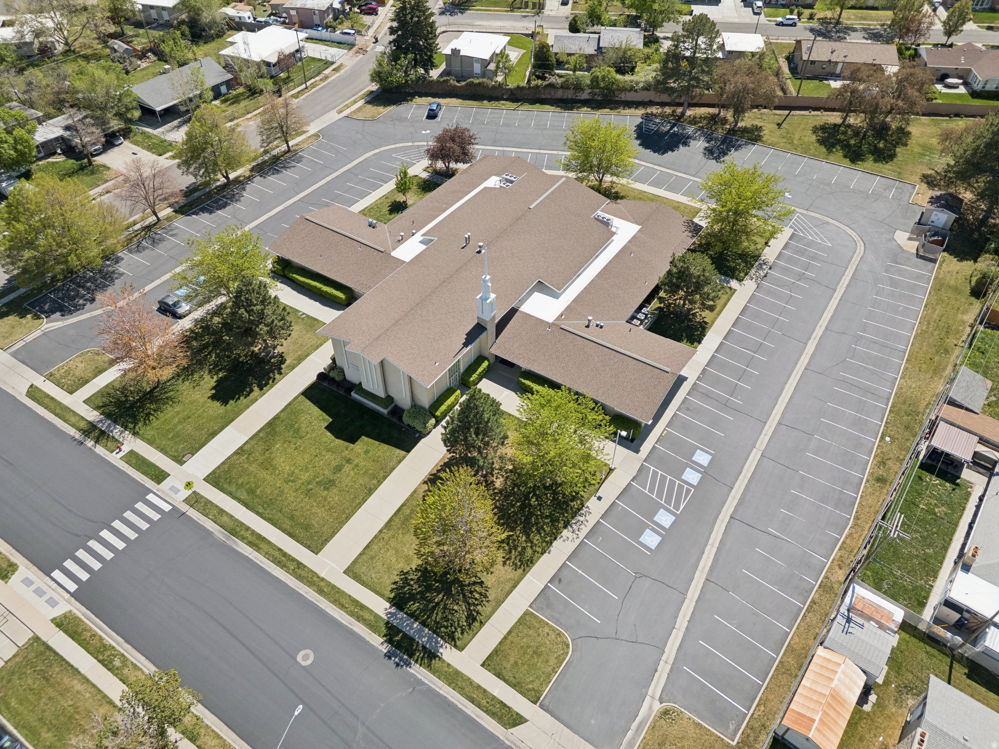 The property located at 4605 Westpoint Drive in West Valley City, Utah, features a building with 15,350 square feet of space and sits on 2.52 acres of R-1-8 land. Offers will be reviewed after the property owner's mandatory 30-day listing period expires. Zoning and allowed uses must be confirmed with the city.