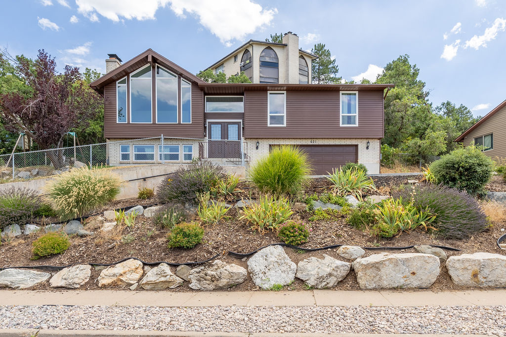 Perched on the hillside of North Salt Lake, with views of the valley below sits this beautiful 4 bedroom, 3 bathroom house ready for you to make your home. The big picture window on the front lets in so much natural light during the day and the views of the valley sunsets can't be beat. With 2 gathering rooms for living, an updated kitchen, 2 wood burning fireplaces and yard perfect for exploring and creating your own outdoor oasis in, this house is the perfect place for you to make the best memories! Updates include updated kitchen in 2025, windows replaced throughout the house, sewer line recently scoped and cleaned, EV charger in the garage and so many more bonuses. This house, in this location with these views and space, is definitely one you don't want to miss. Use our preferred lender for a 1-0 buydown. What a deal.  Come see it for yourself, fall in love with it and make us an offer. All information to be verified by buyer.