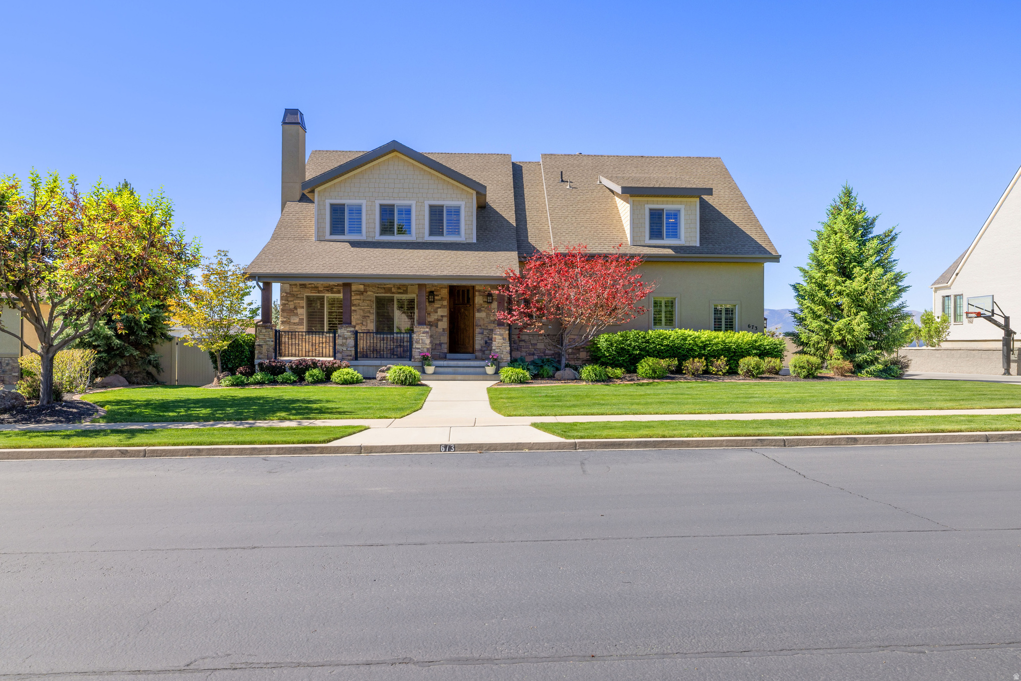 Located in one of the most highly sought-after neighborhoods in the heart of American Fork, this stunning two-story home with a fully finished walkout basement offers the perfect combination of space, function, and location. Set on a  0.29-acre lot, the property boasts 5,075 total square feet with five bedrooms and four and a half bathrooms, thoughtfully designed for both comfortable living and effortless entertaining.  The main level flows seamlessly with thoughtful living spaces, while the upper level provides well-appointed bedrooms and privacy. The walkout basement adds incredible versatility, offering additional living space with direct backyard access-ideal for gatherings, guests, or multi-generational living. A three-car garage is paired with an abundance of concrete along the side of the home, providing exceptional parking options for trailers, toys, or extra vehicles, a rare and highly desirable feature in this area.  Step outside to enjoy the covered patio, perfect for relaxing or hosting while overlooking  the Utah valley. With its prime location near schools, parks, shopping, and convenient commuter access, this home delivers the lifestyle and setting buyers are actively searching for in American Fork.    Square footage figures are provided as a courtesy estimate only and were obtained from county records.  Buyer is advised to obtain an independent measurement.