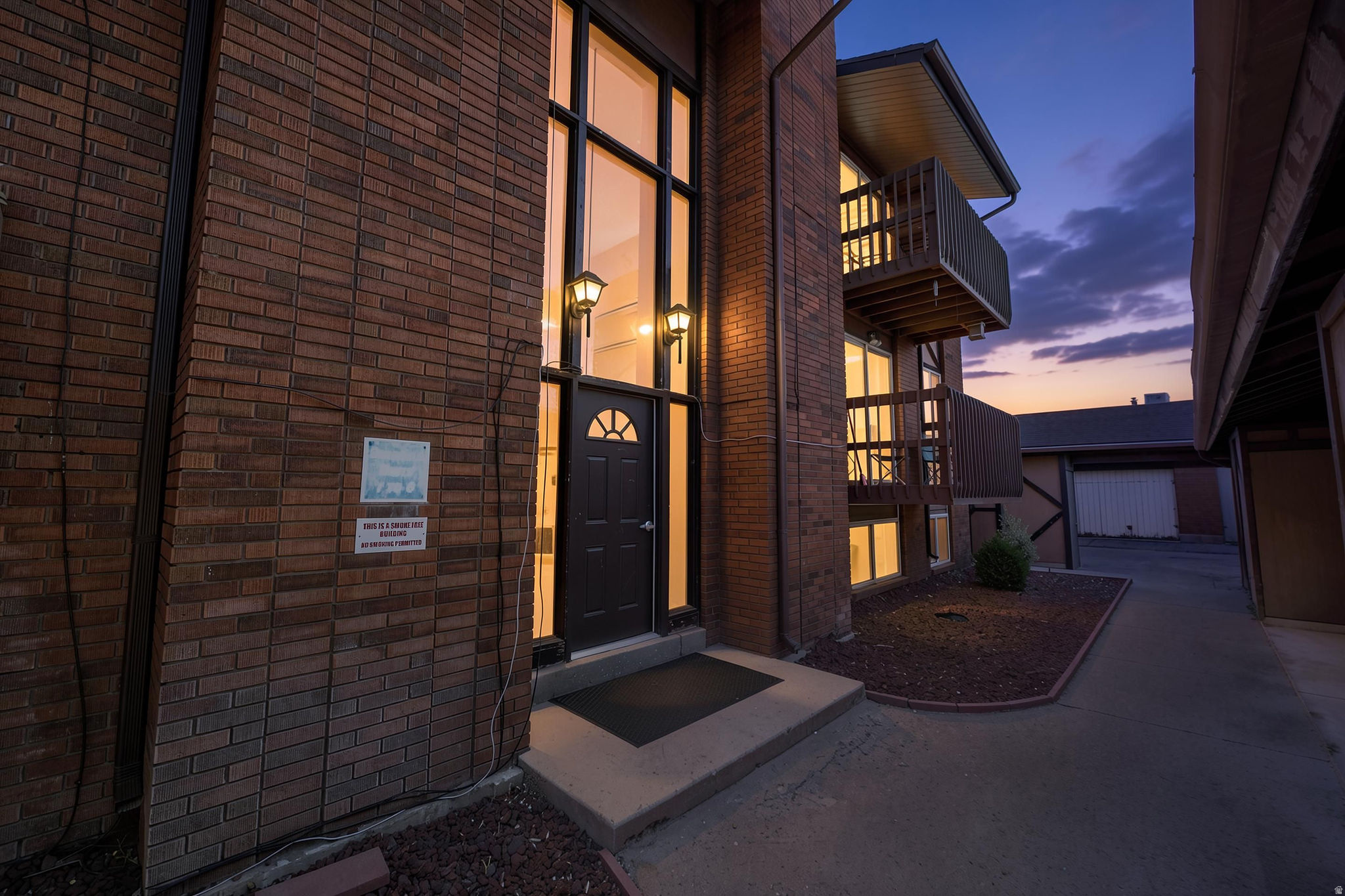 Say hello to this easy, low-maintenance living in this desirable ground-level end-unit condo in the heart of Roy! Featuring fresh paint, updated flooring, and an abundance of natural light, this move-in-ready home offers both comfort and convenience. The upgraded washer, dryer, refrigerator, and double oven are all included, making your transition seamless.  Inside, you'll find a functional floor plan with a spacious living room, dedicated dining area, and a private primary suite complete with its own bathroom. Stay cool during the summer months with the ground-level location, and cozy up by the charming brick fireplace during the winter.  Step outside to enjoy mature landscaping, a peaceful community setting, and a nearby picnic area perfect for relaxing outdoors. The home also includes two covered carport parking spaces and a private lockable storage area for added convenience.  The HOA covers insurance, exterior maintenance, water, sewer, trash, and snow removal, allowing you to enjoy worry-free living year-round. Conveniently located near schools, shopping, dining, and major commuter routes, this home is perfect for first-time buyers, downsizers, or anyone looking for comfortable living with minimal upkeep.  Schedule your private showing today!