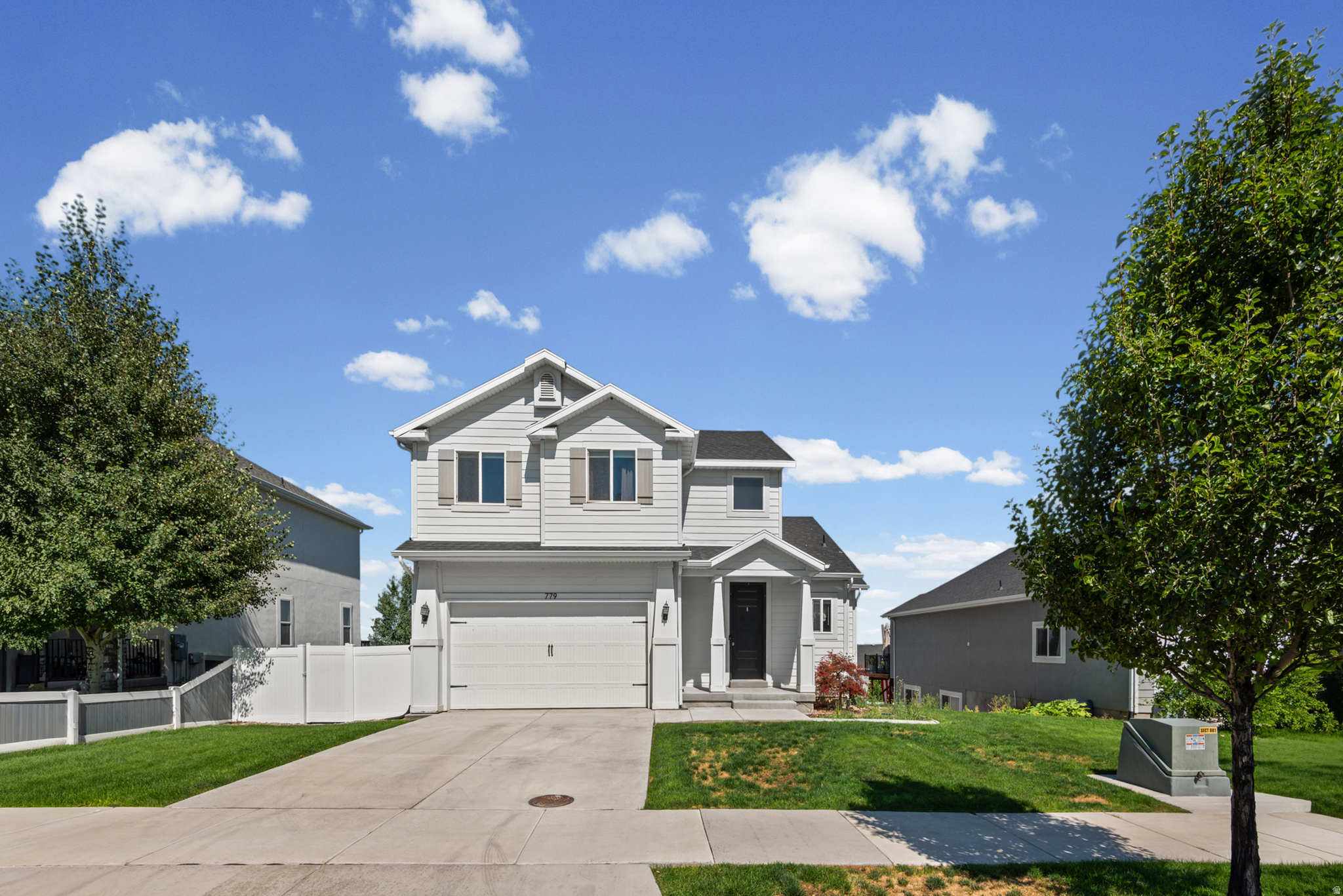 Welcome home to The Views! This two-story beauty offers valley and lake views, tons of natural light, and an open-concept layout perfect for everyday living and entertaining. The main floor flows effortlessly between the kitchen, dining, and living room, anchored by a cozy gas fireplace. The kitchen shines with gray shaker cabinets, stainless steel appliances, quartz counters, and a walk-in pantry. Step through the sliding door to a private deck with mountain views - perfect for morning coffee or evening unwinding. Upstairs, the primary suite impresses with vaulted ceilings and a private bath, joined by two more bedrooms, a second full bath, and a convenient upstairs laundry room. Downstairs, a walk-out basement with separate entrance is ready for your vision - add bedrooms, a bath, extra living space, or all three. Two-car garage and fenced backyard complete the package. Unbeatable location: minutes to the golf course, Utah Lake beach, hiking trails, and the scenic river trail to Springville. Shopping, dining, schools, and a community pool are all close by. Don't miss this one - schedule your showing today!  Measurements provided as a courtesy only; buyer to verify all information.